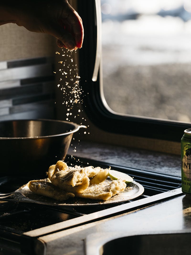 Plate of Fried White Fish with Lime Salt in kitchen RV. 