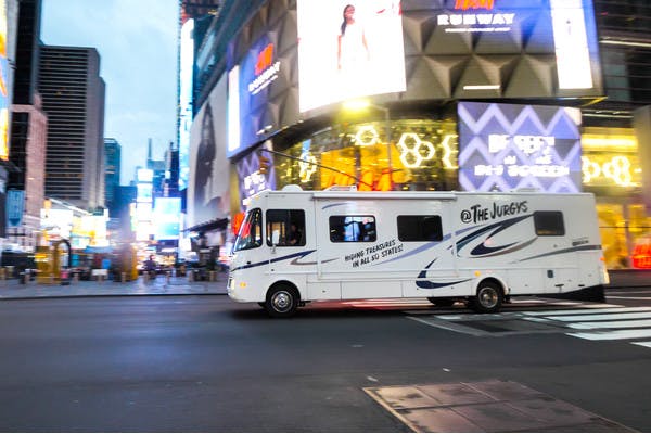The Jurgy's Class A Thor motorhome driving through the streets of Times Square in New York City.