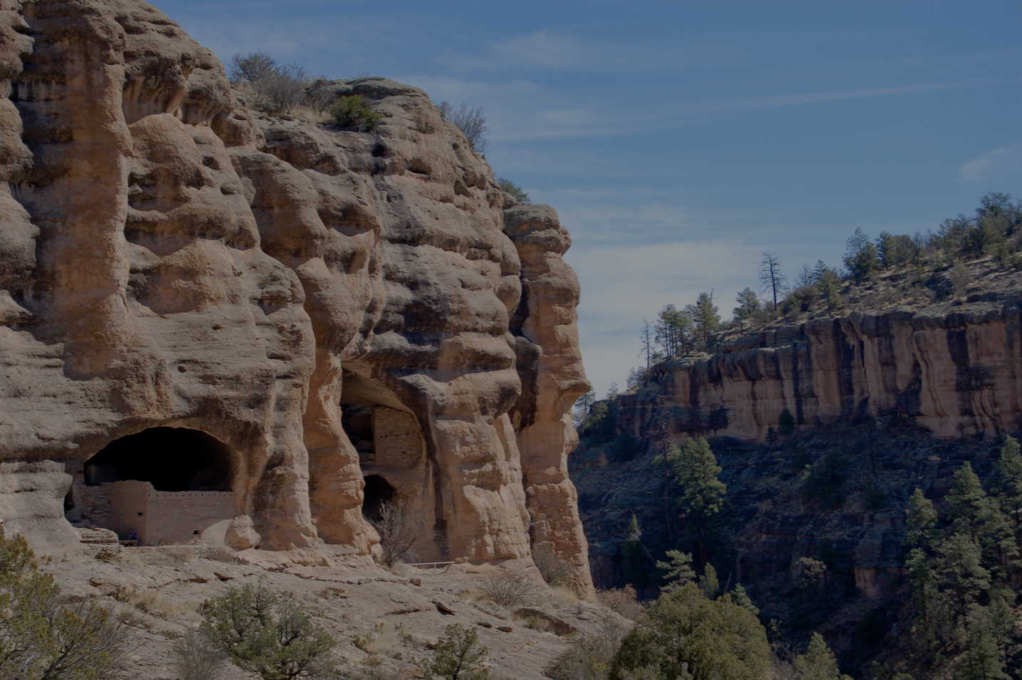 Cave cliff formations inside tan colored mountains