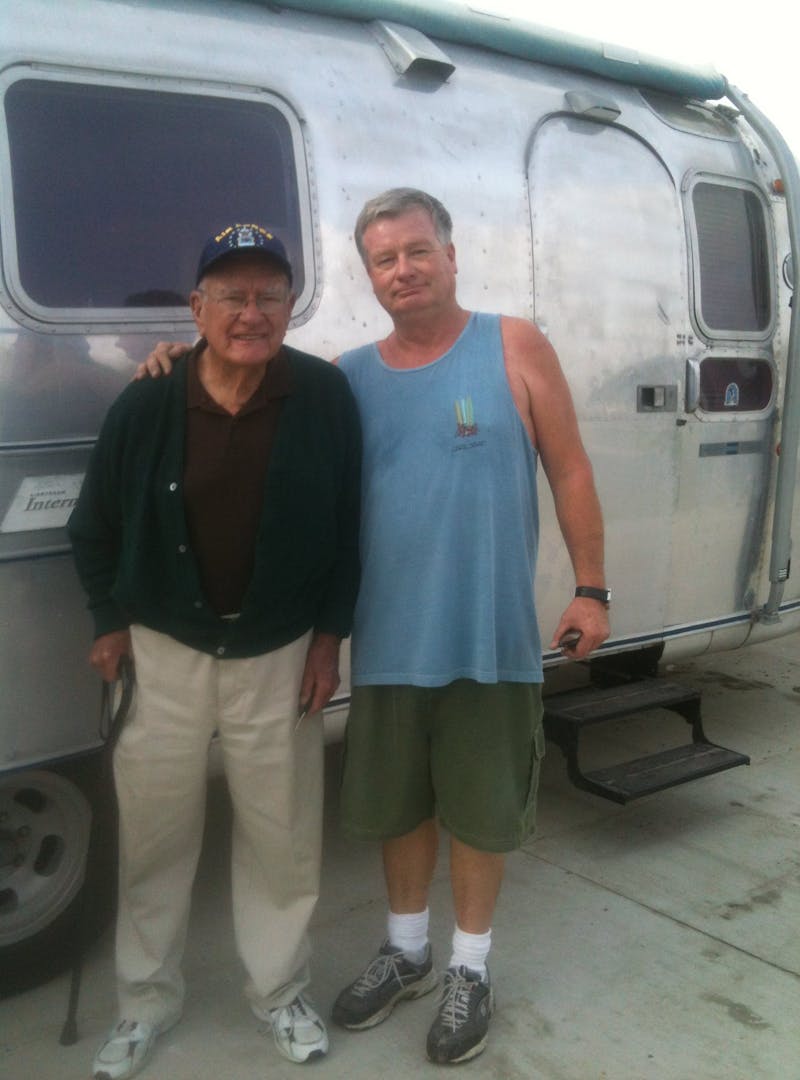 Bill Hartig standing with his elderly father in front of the Airstream.