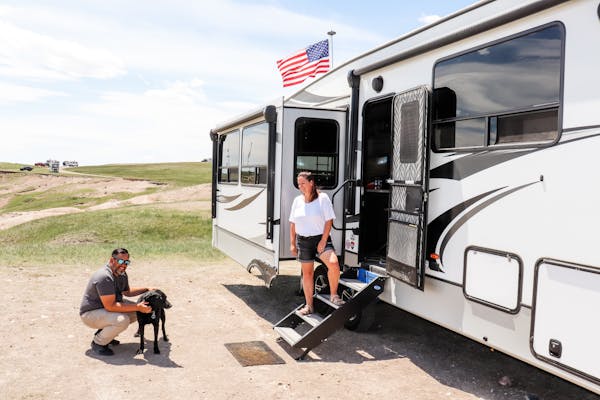 Kaylee and Steve Techau in front of their Keystone Cougar