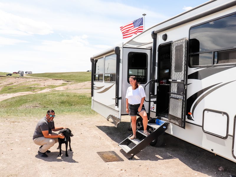 Kaylee and Steve Techau in front of their Keystone Cougar