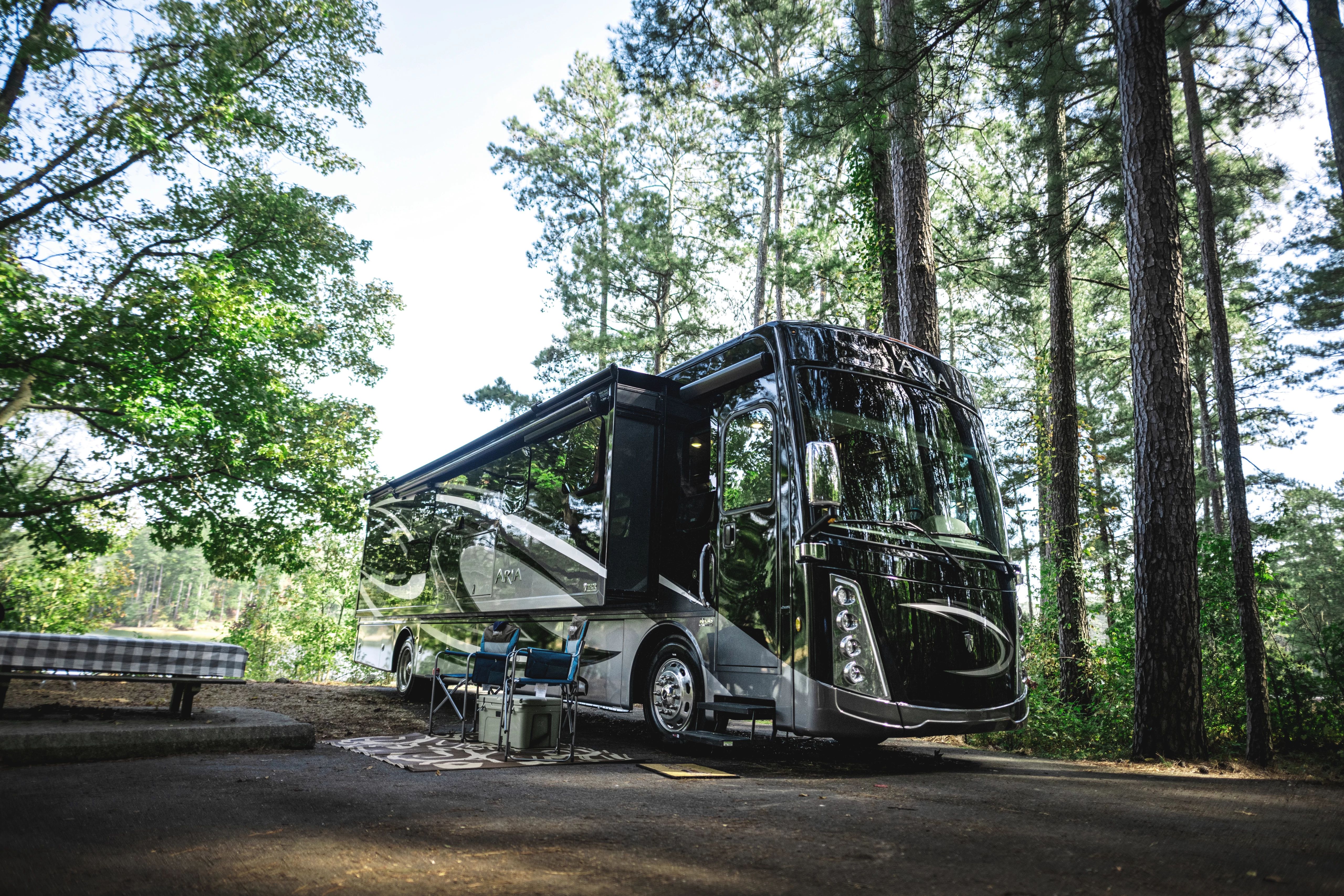 A thor motor coach class a motorhome parked at a campsite 