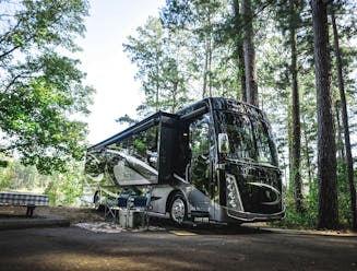 A thor motor coach class a motorhome parked at a campsite