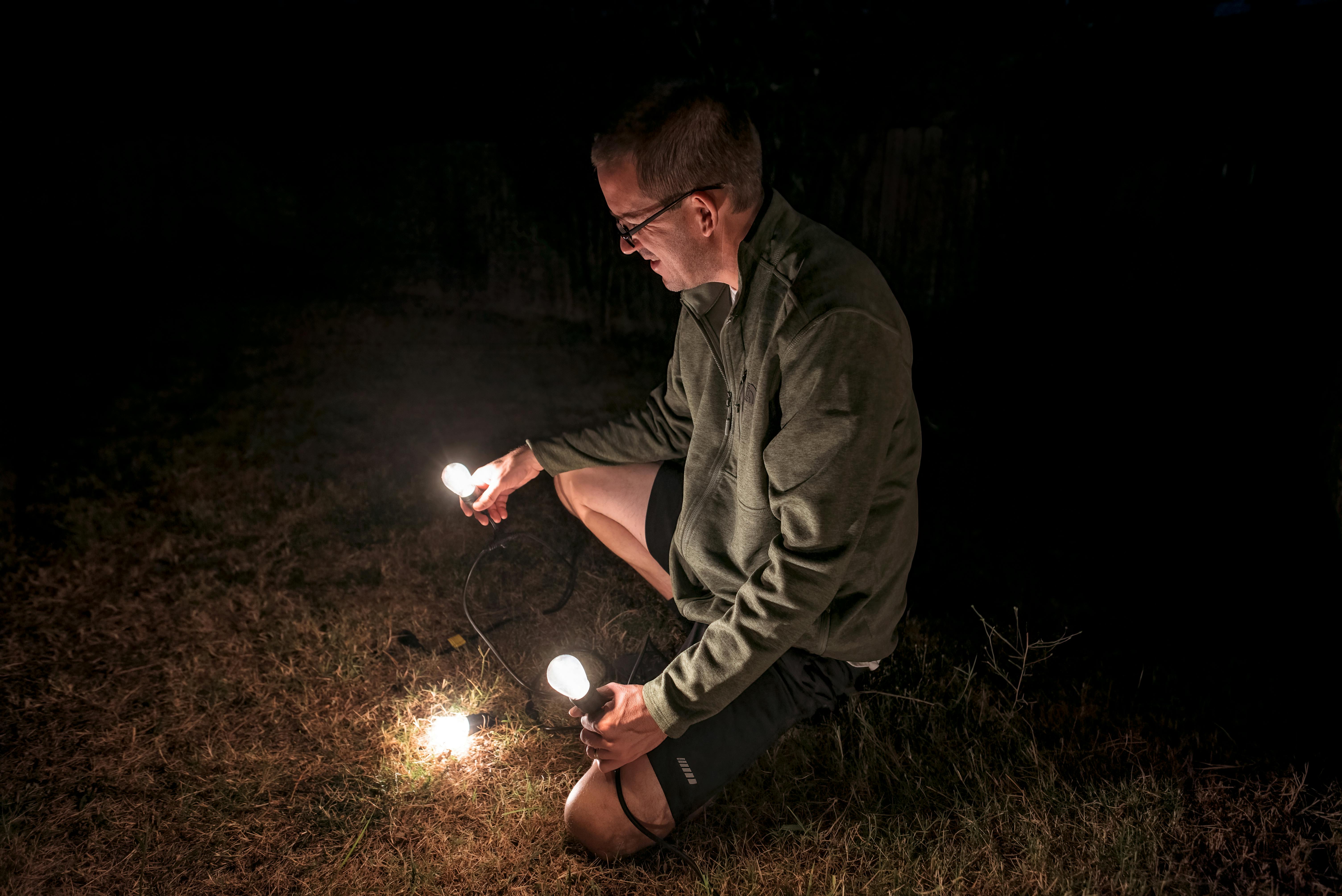 Jason Takacs putting up string lights