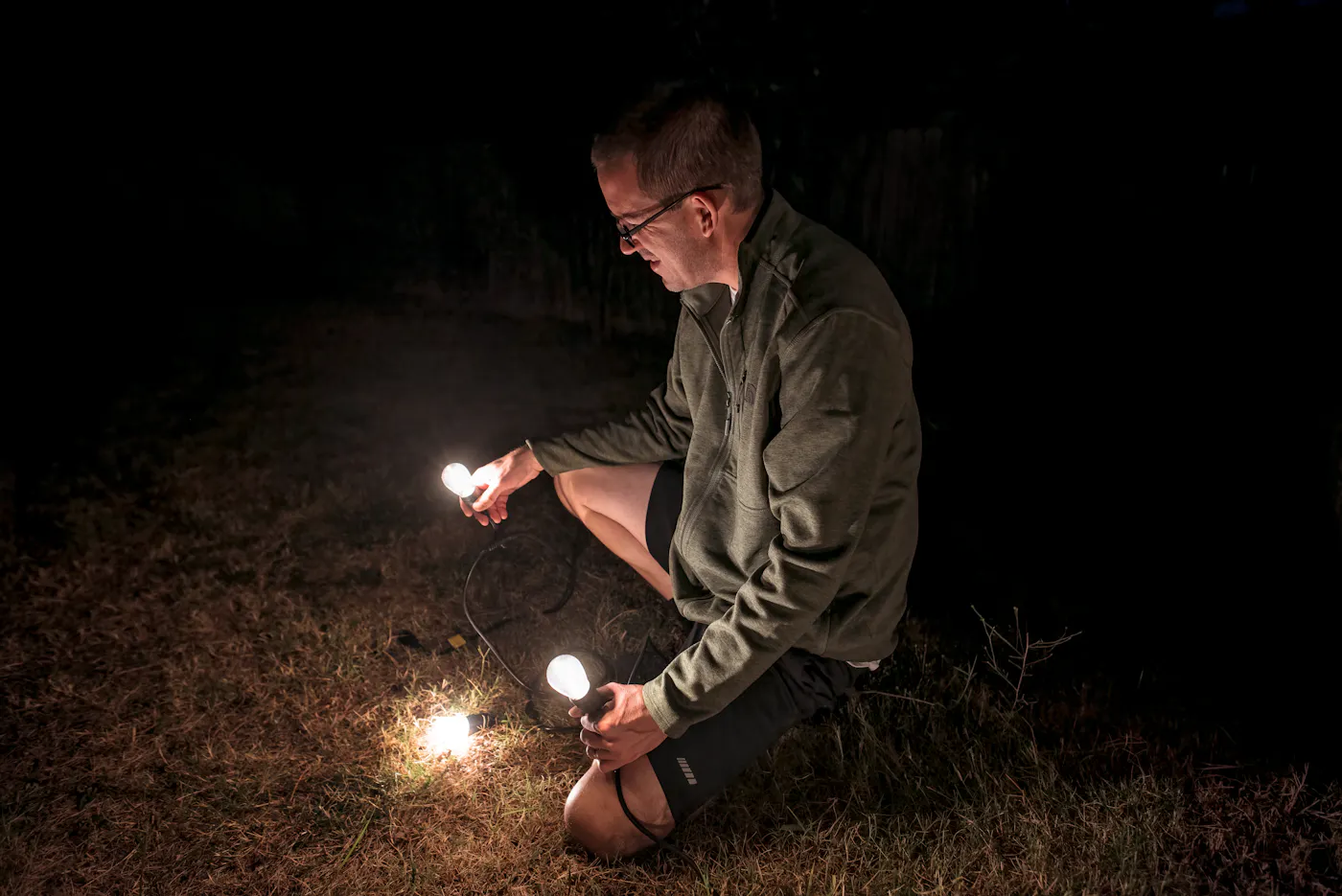 Jason Takacs putting up string lights
