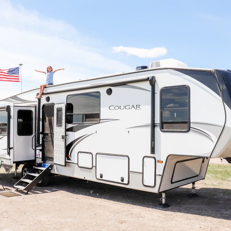 Kaylee and Steve Techau's daughter sitting on top of their Keystone Cougar