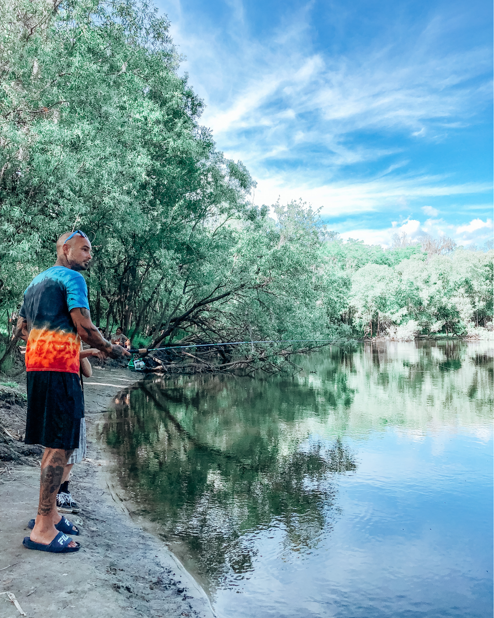 Justin Russell fishing at a pond.