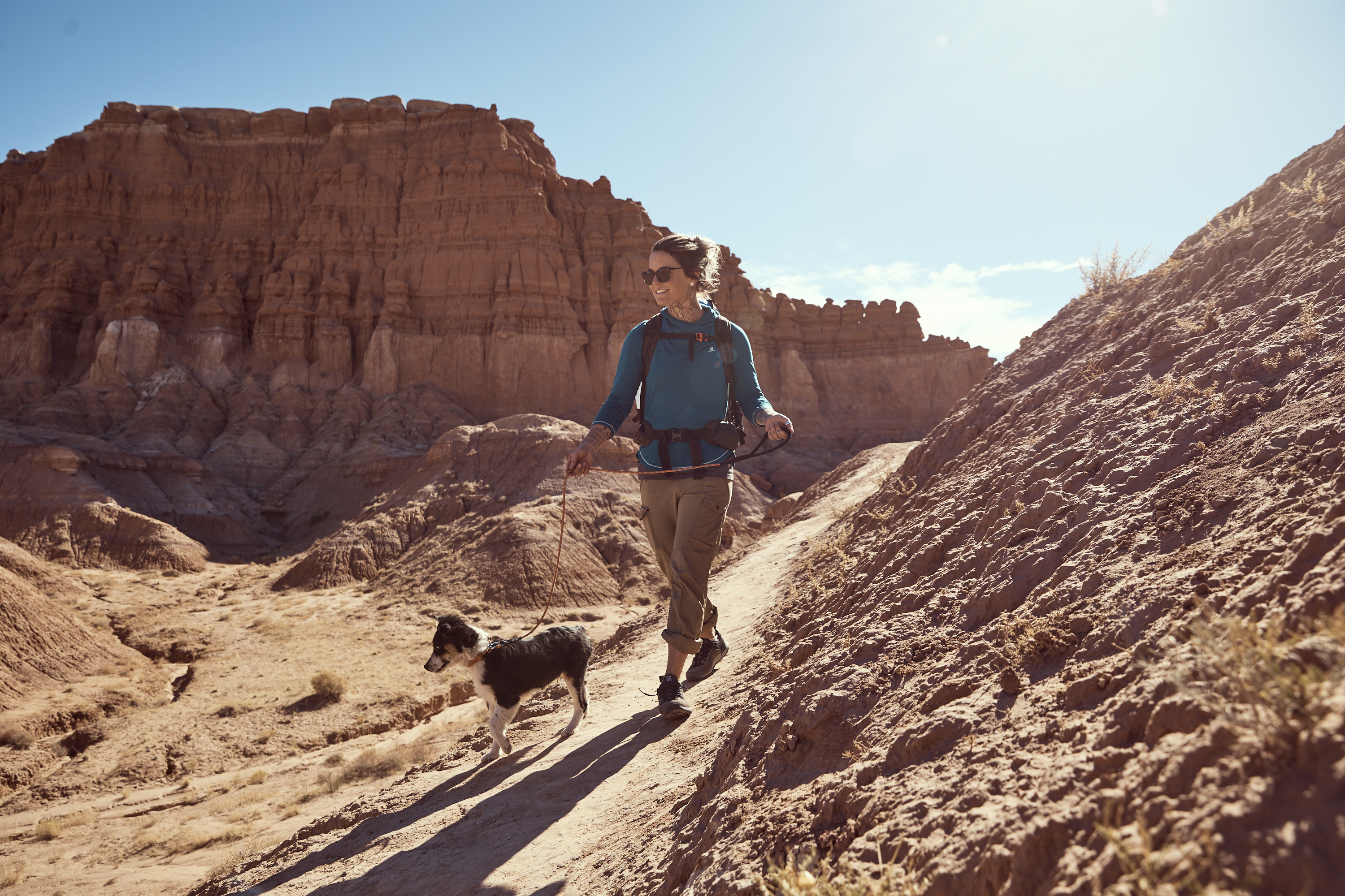 Kalen Thorien walks her dog on a desert trail.
