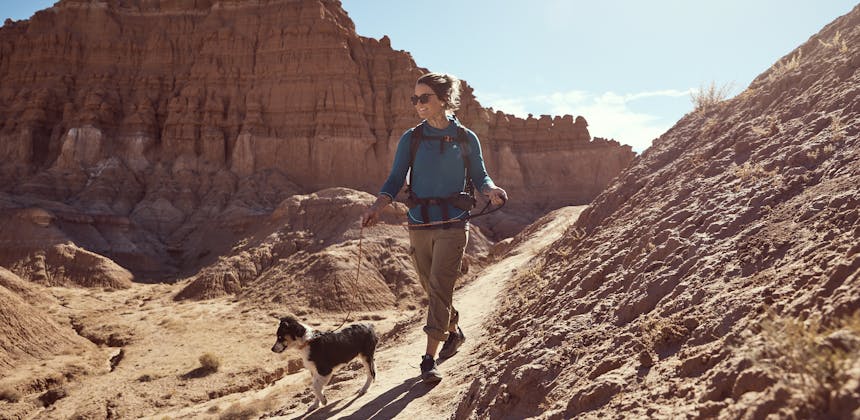 Kalen Thorien walks her dog on a desert trail.