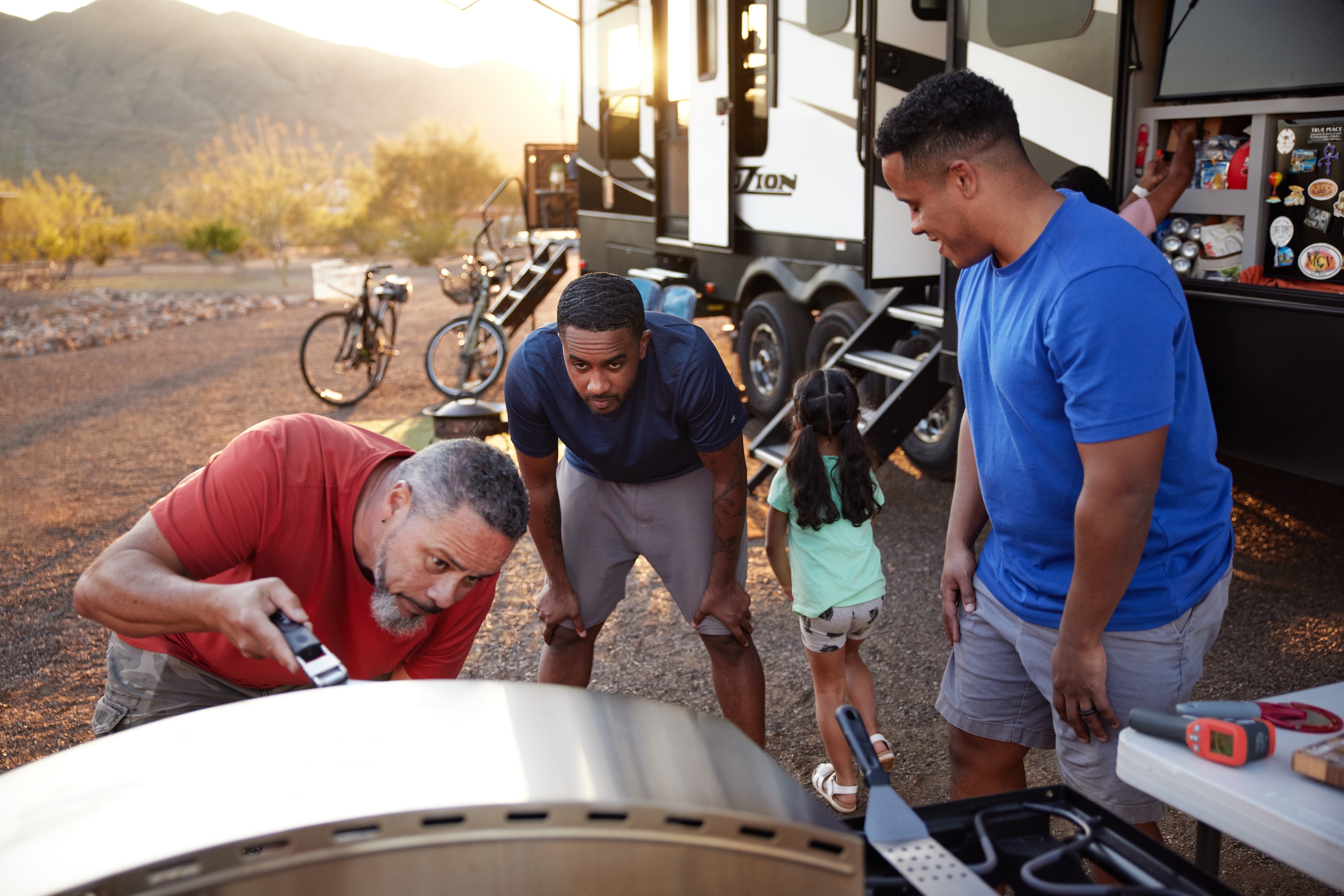 Warren and his two sons cook pizza in a pizza oven outside of their Keystone Fuzion.