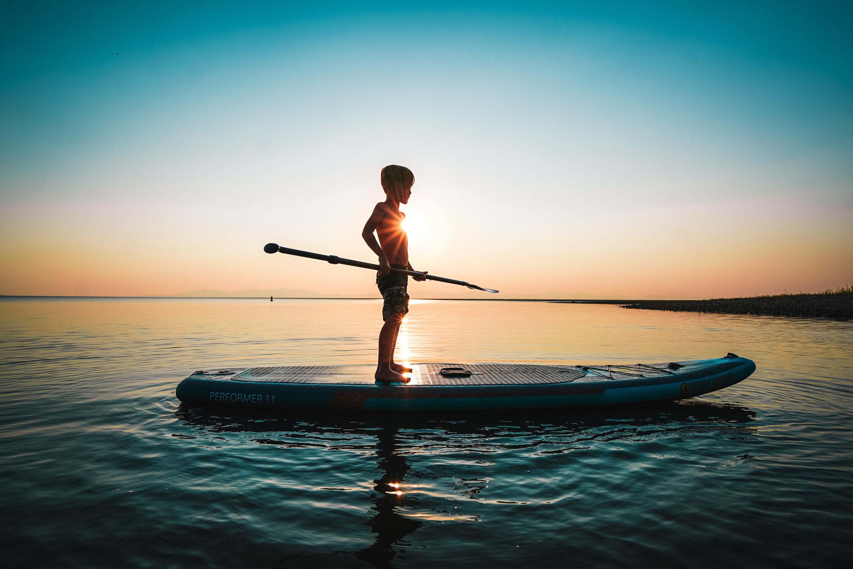 Renee Tilby's child on a stand up paddle board