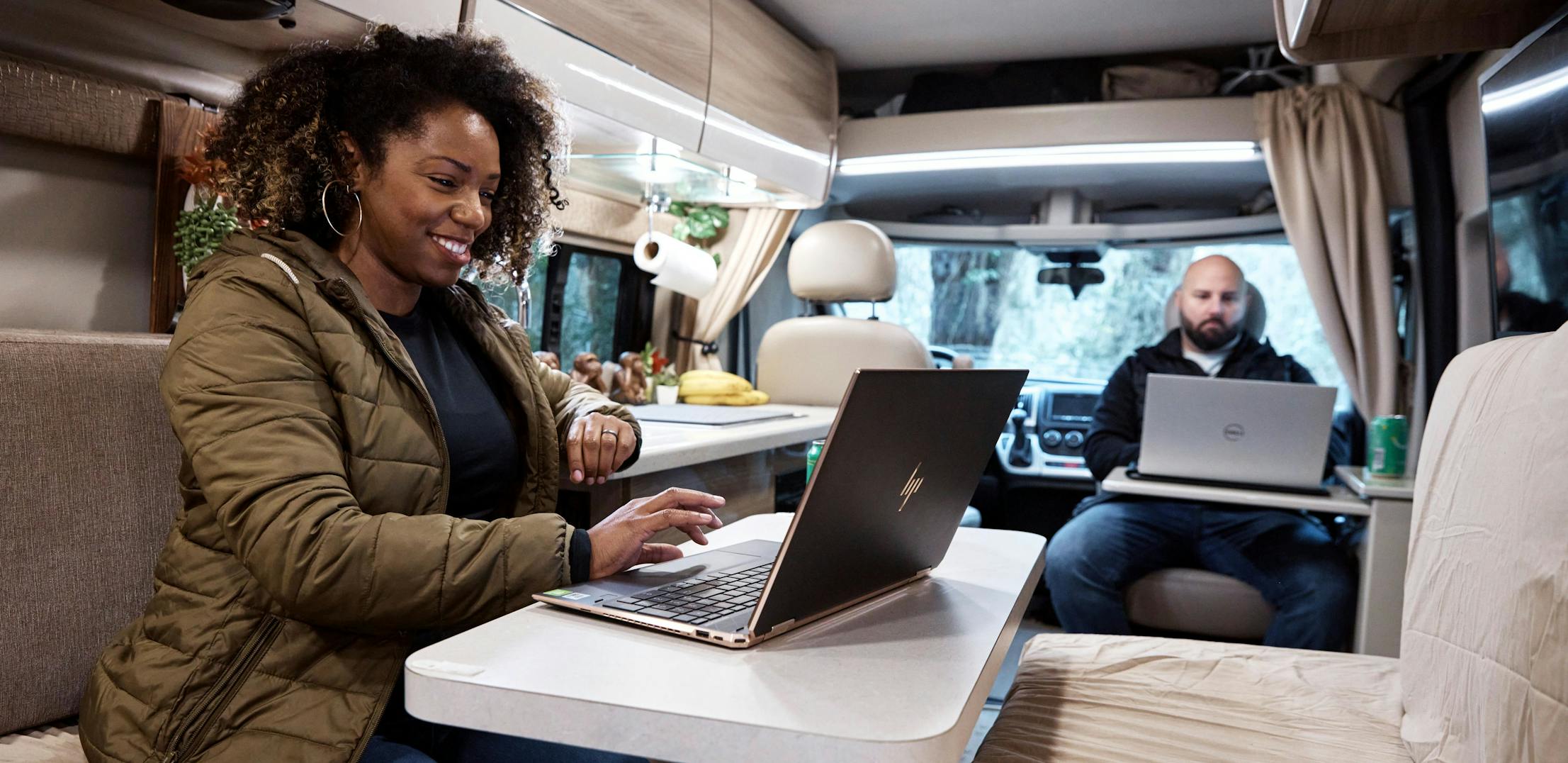 Gabe and Rocio Rivero working inside their RV on their computers