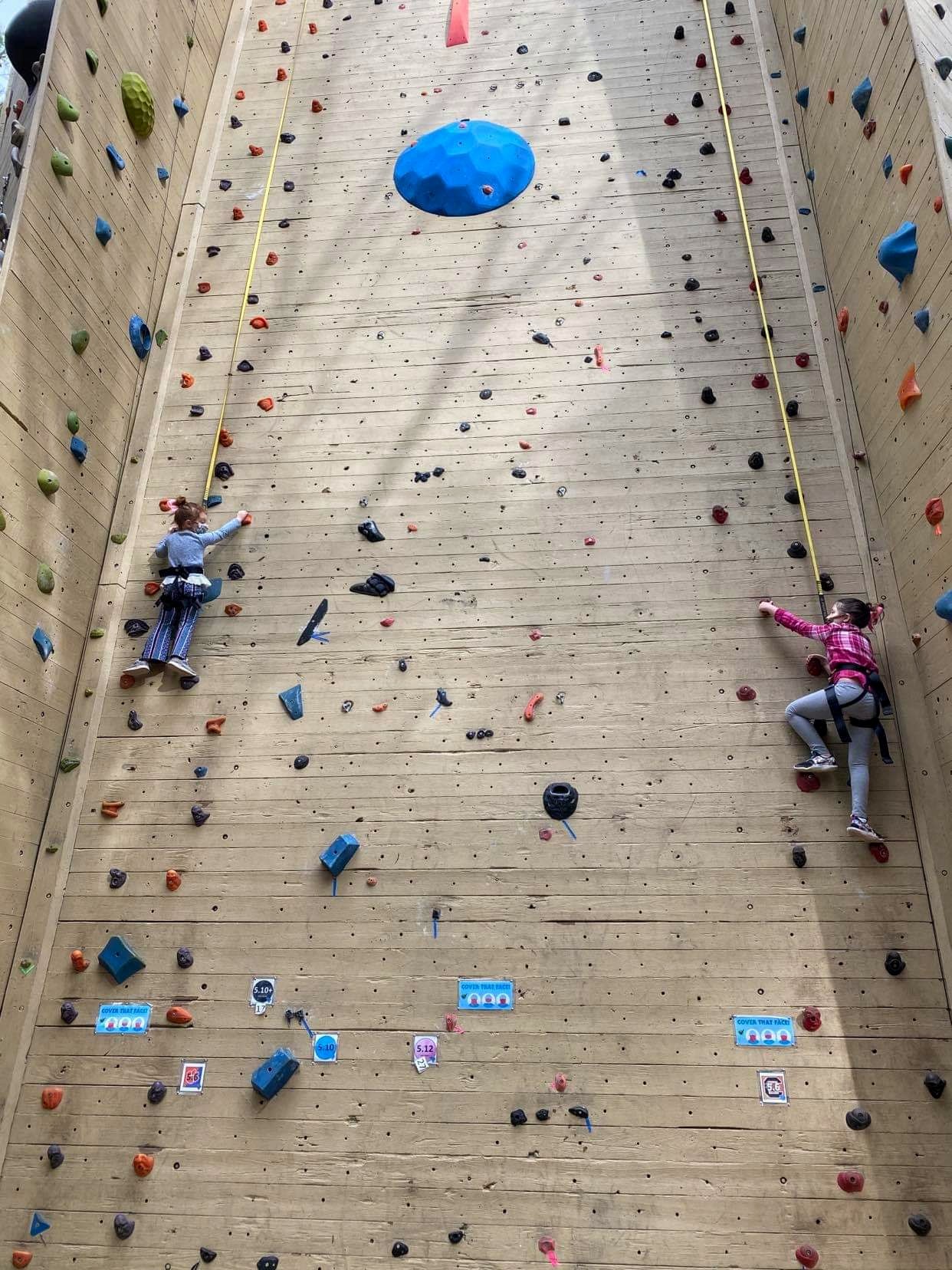 Rosie and Ila Roberson climbing up a rock wall