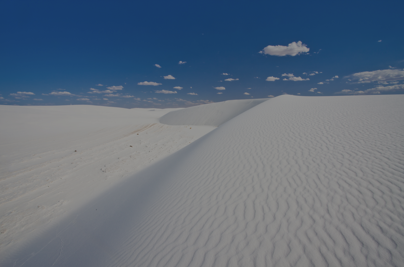 White sand dunes against blue sky at White Sands National Park