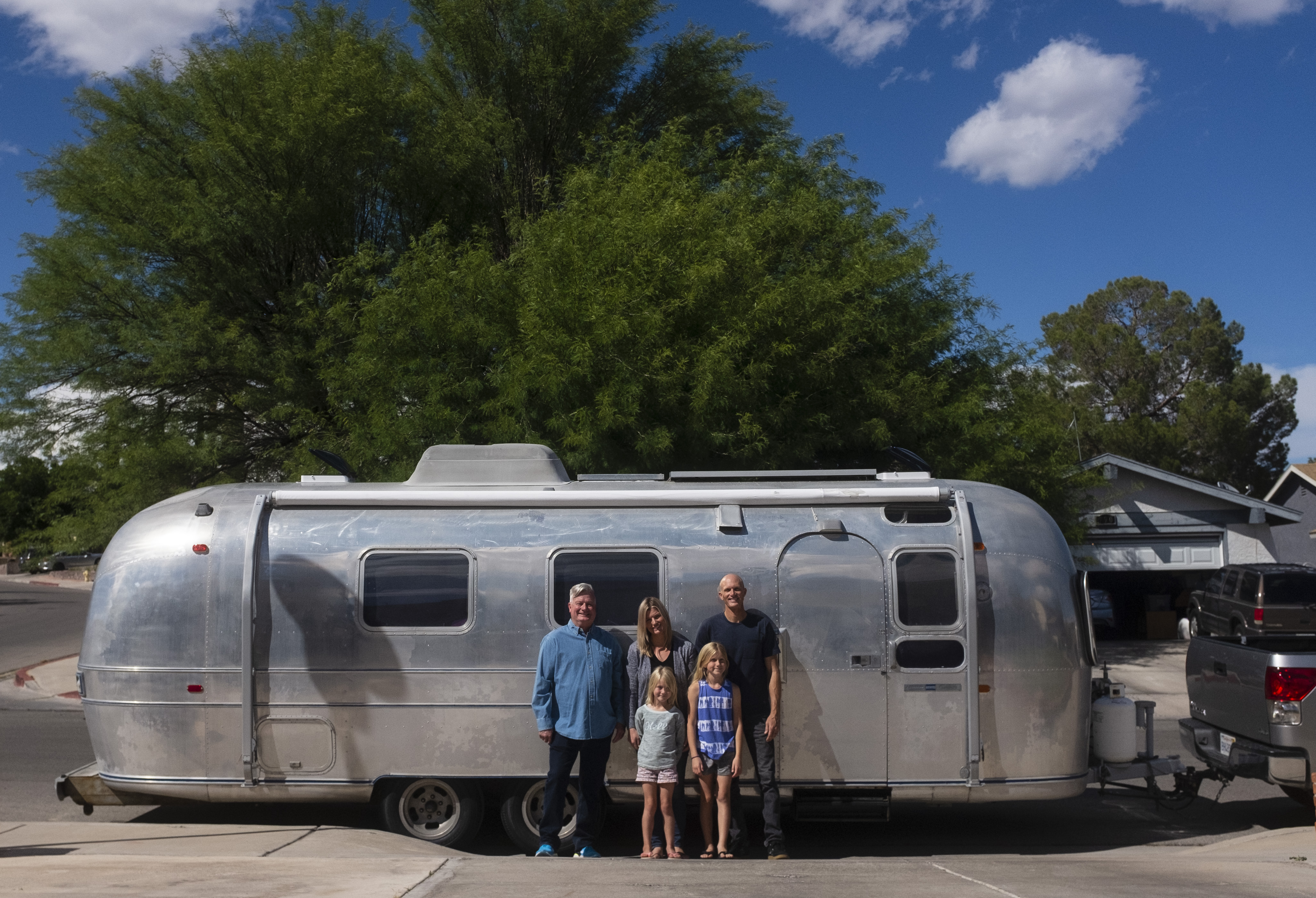 Bill Hartig with his daughter Kate, her husband Nate, and their two daughters, posed in front of their family RV.
