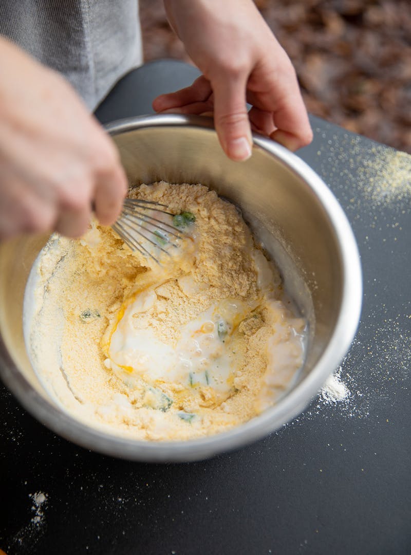 Mixing up the batter for hush puppies.