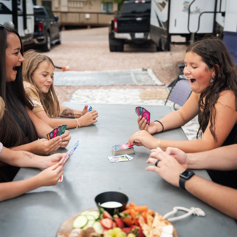 Amanda and Darren Bone playing cards with their kids