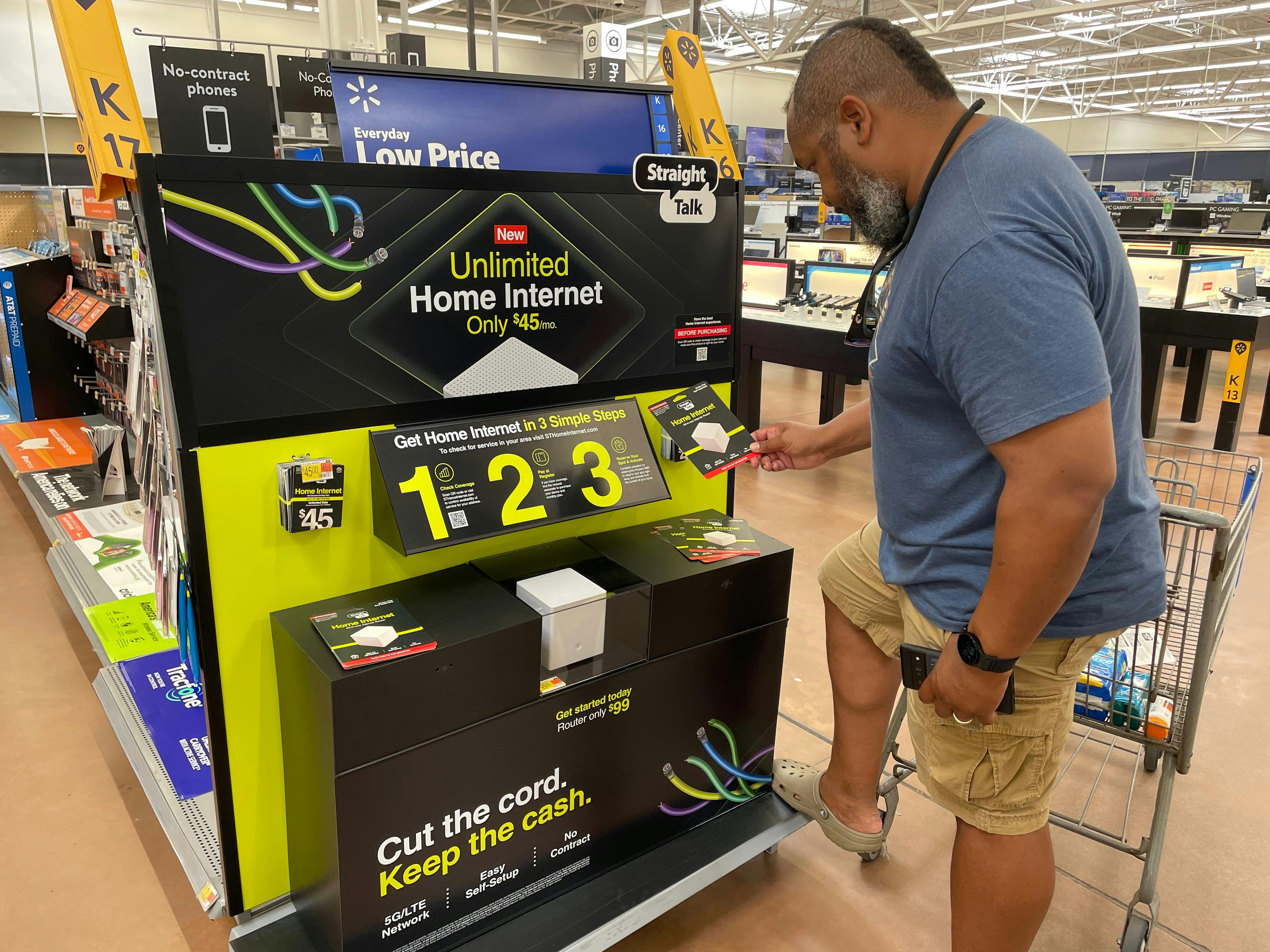 Ben McMillan looking at home internet plans inside wal mart 