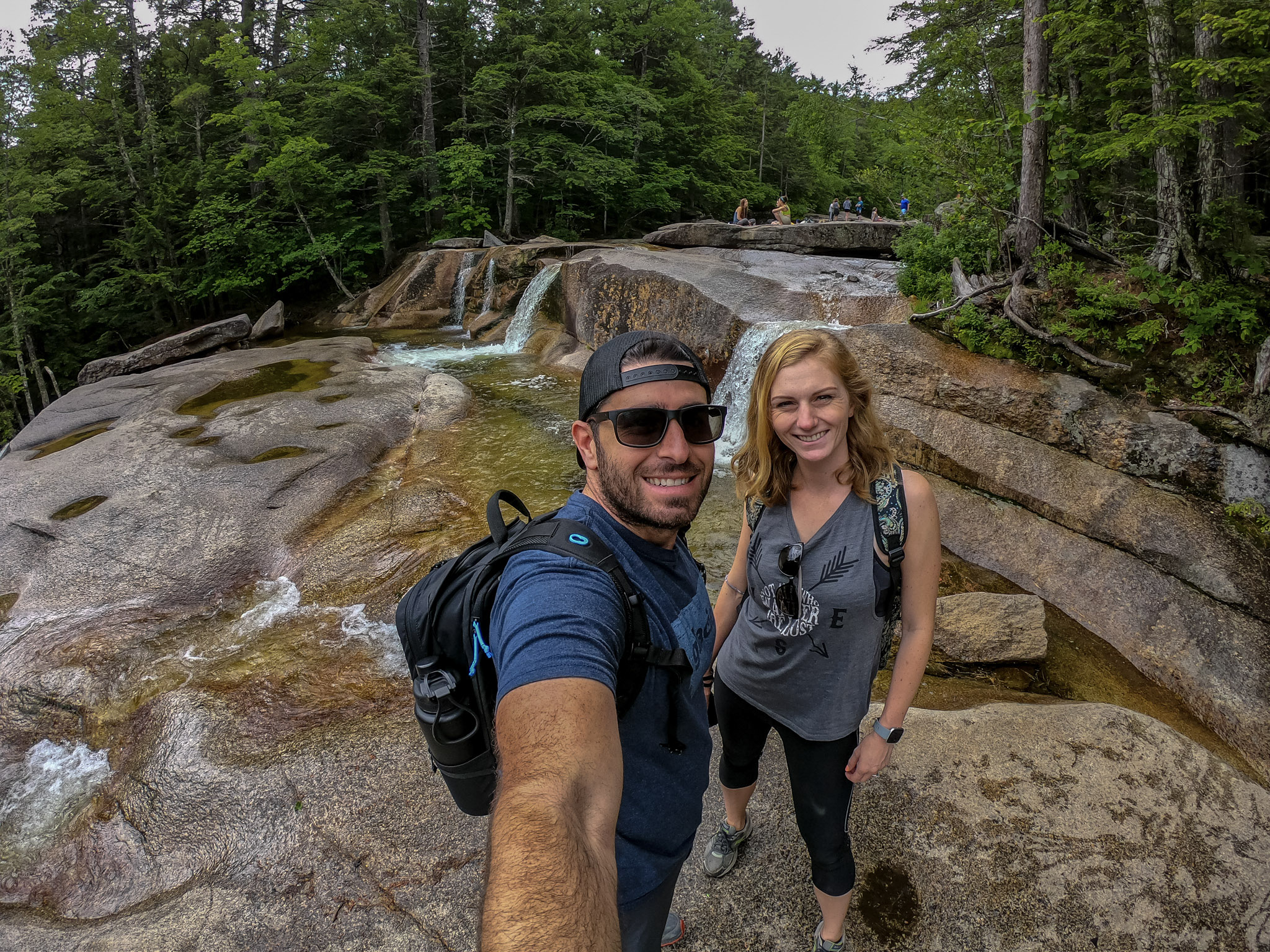Jesse and Mel taking a selfie with waterfalls in the background. 