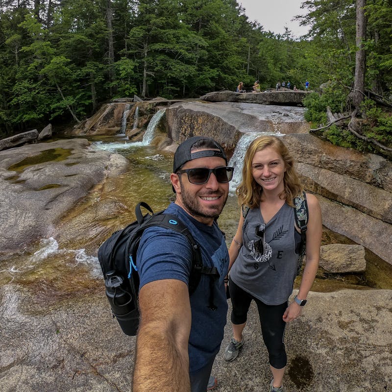 Jesse and Mel taking a selfie with waterfalls in the background.