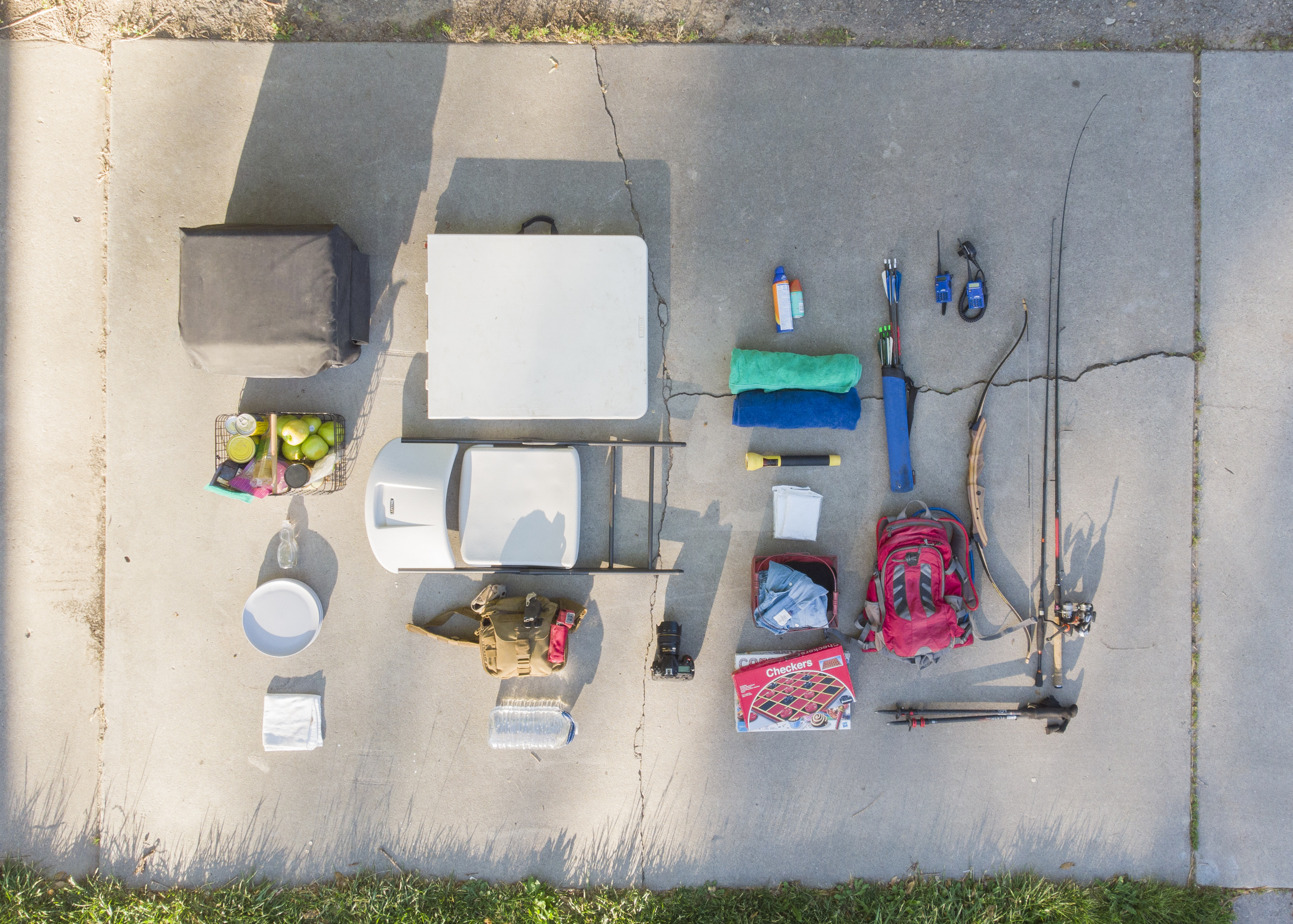Camping gear laid out on a sidewalk 