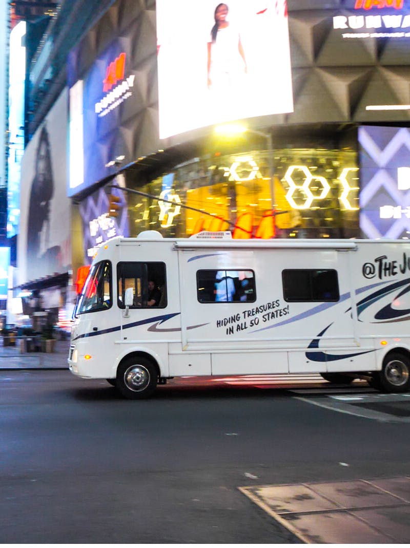 The Jurgy's Class A Thor motorhome driving through the streets of Times Square in New York City.
