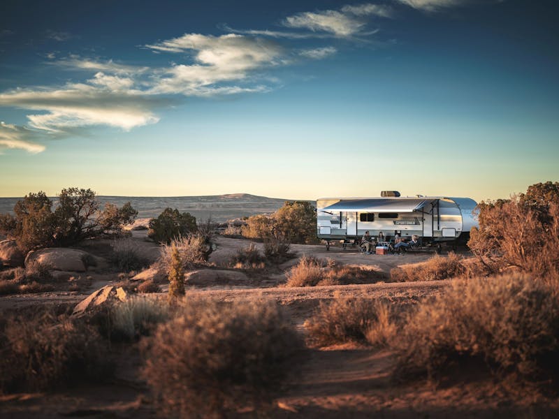A family camping in a KZ Sportsmen in the desert