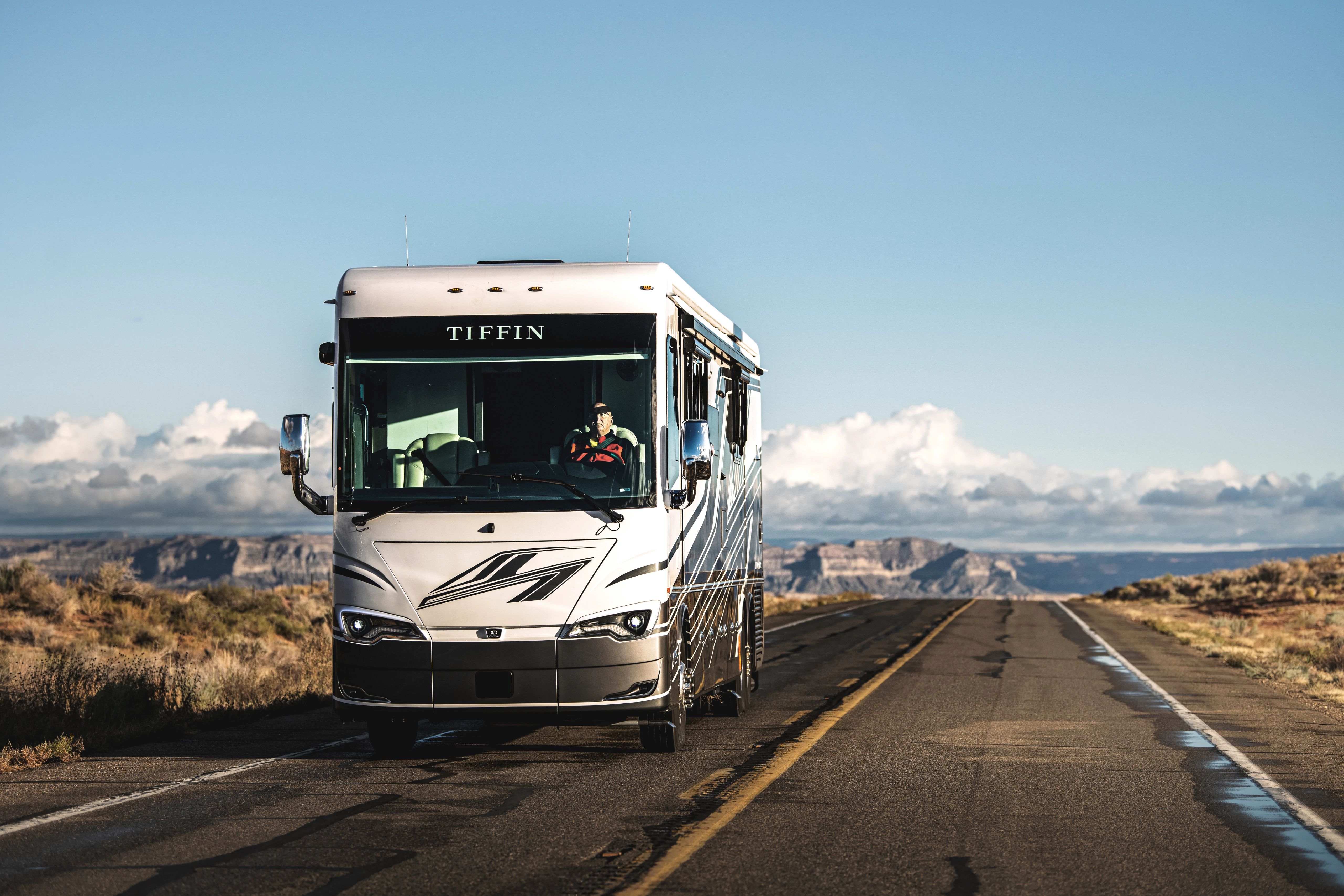 tiffin allegro bus driving down the road 