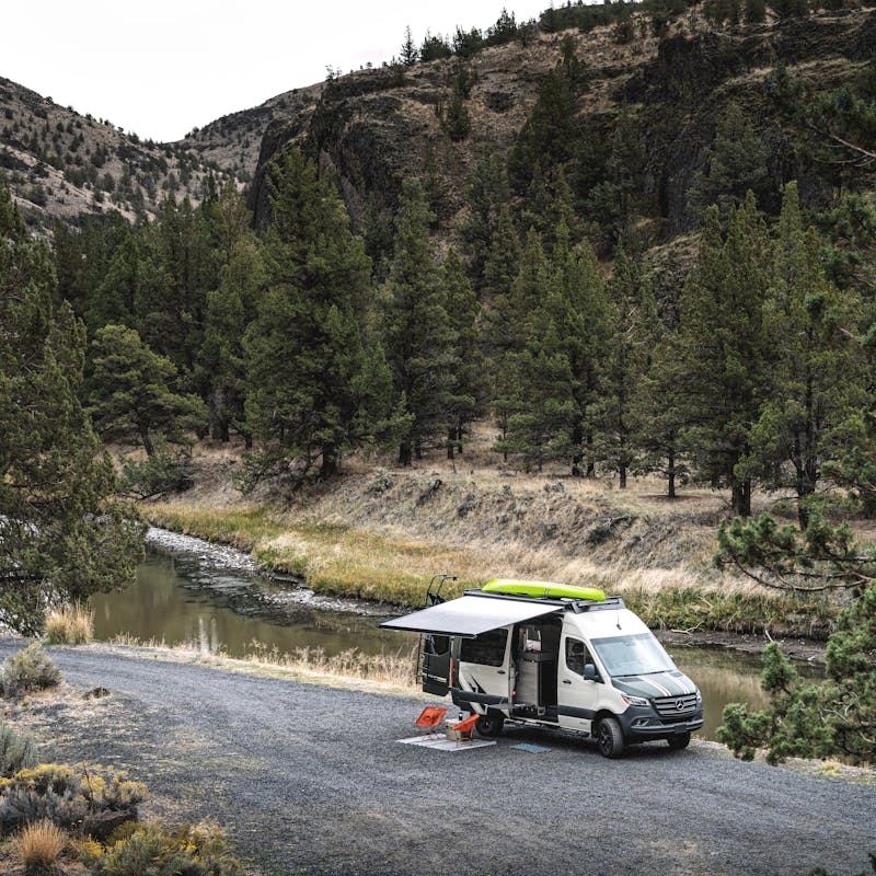 A Jayco Terrain camper van parked next to a river