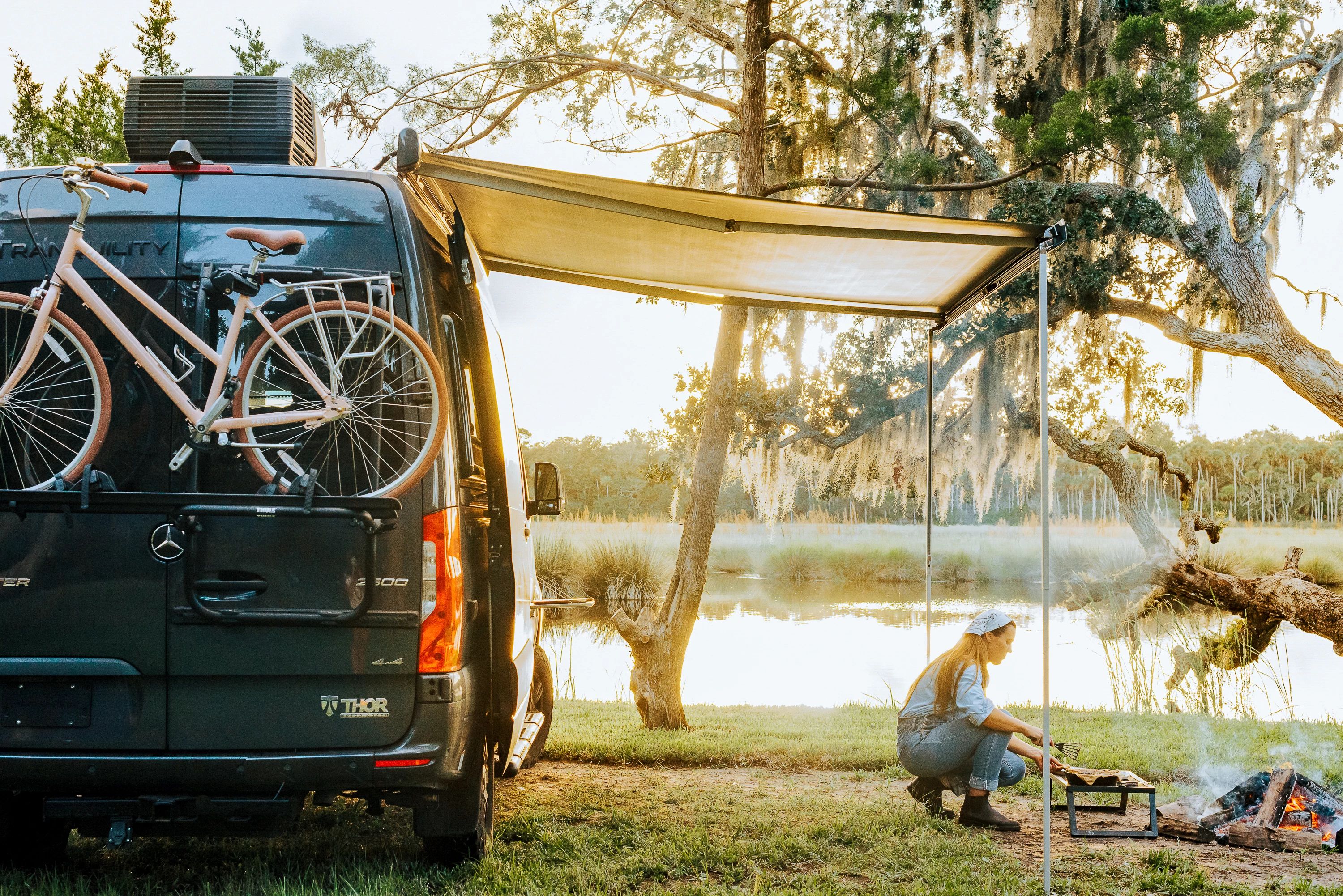 Sarah Glover tending to a fire go cook lobster pie