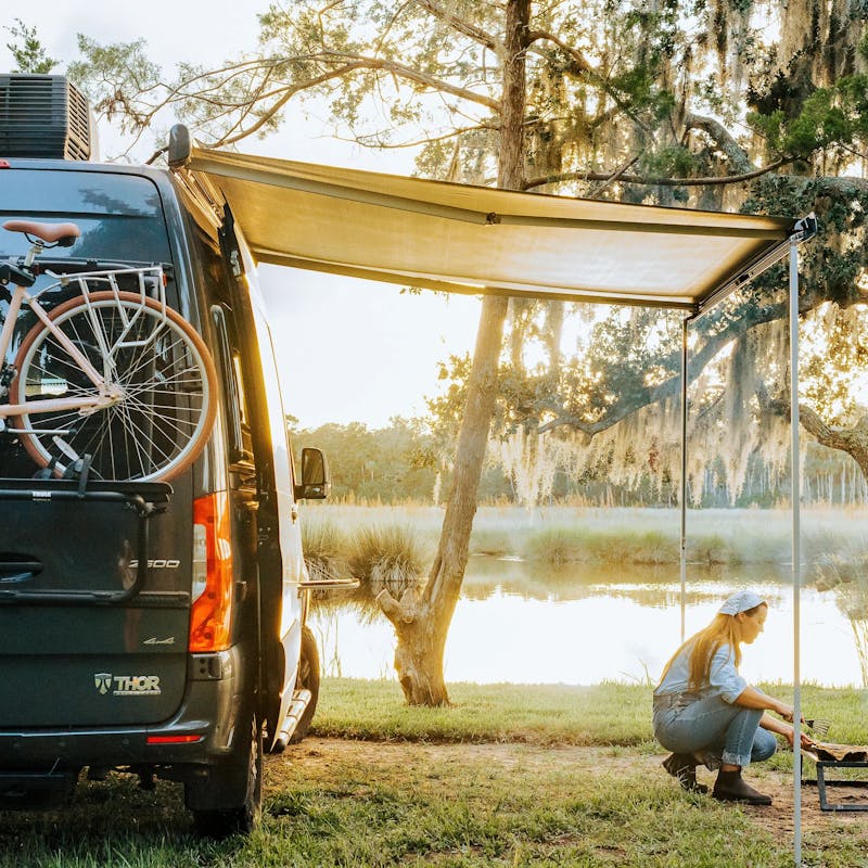 Sarah Glover tending to a fire go cook lobster pie