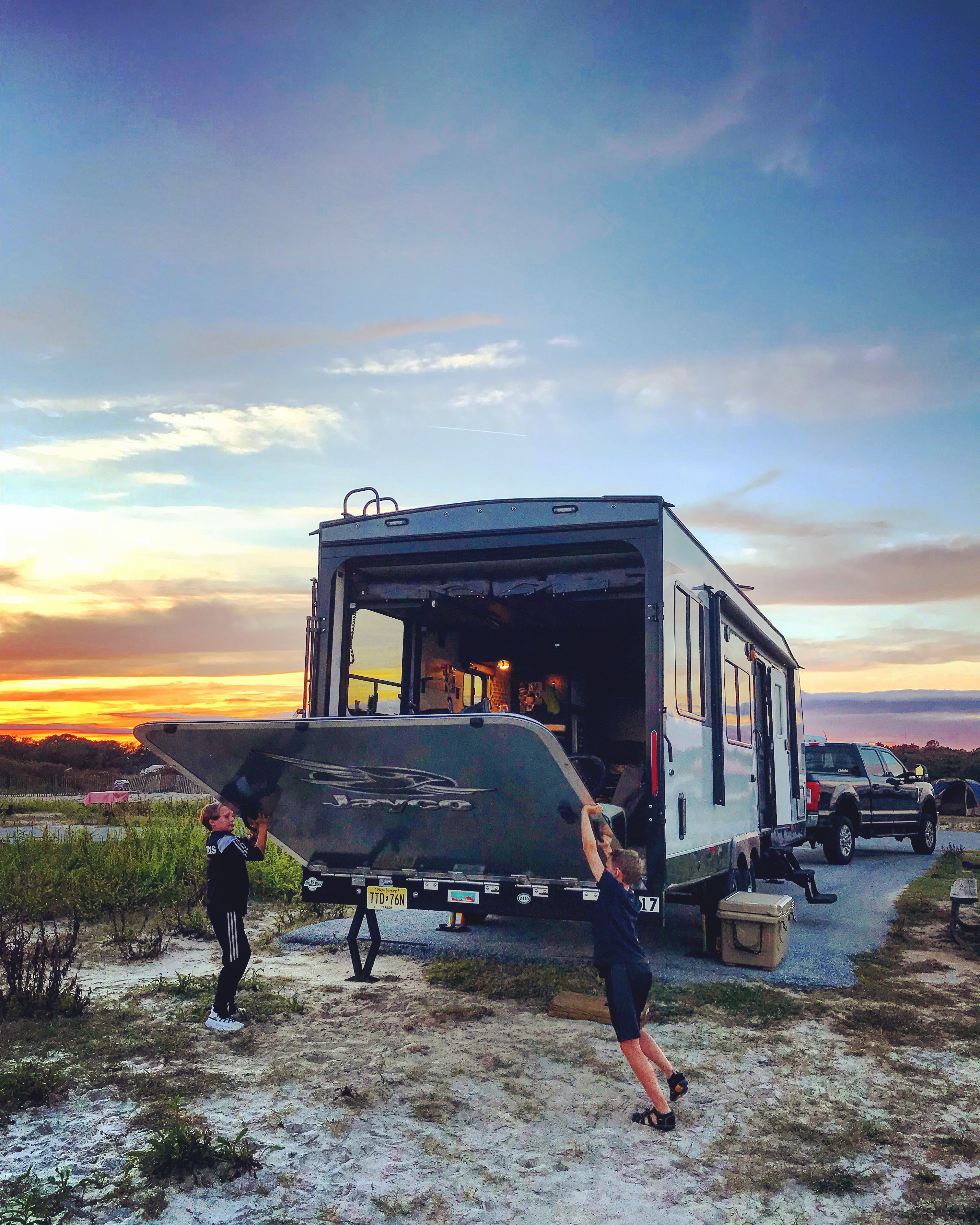 Kids playing outside an RV.