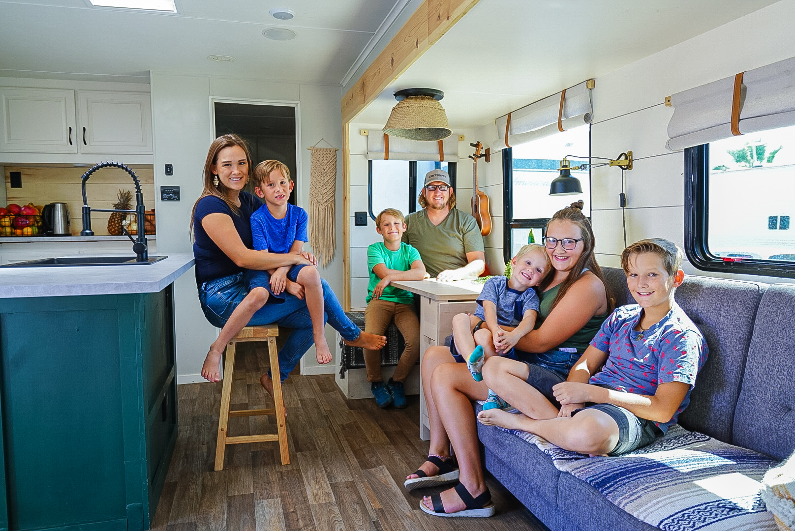 Renee Tilby and her family take a photo in the kitchen and living area of their Jayco Jay Flight