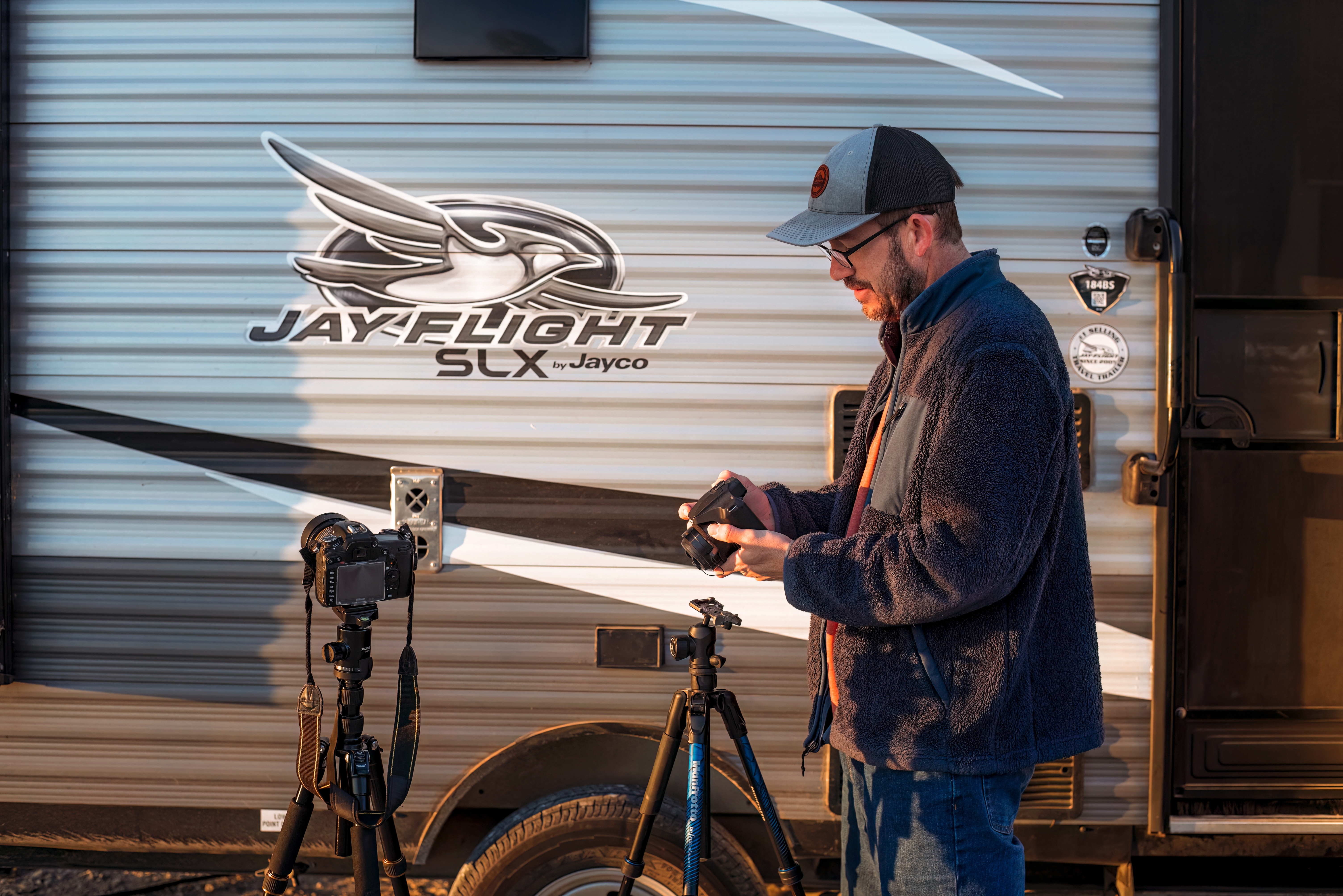 Jason Takacs setting up his camera equipment outside of his Jayco Jay Flight