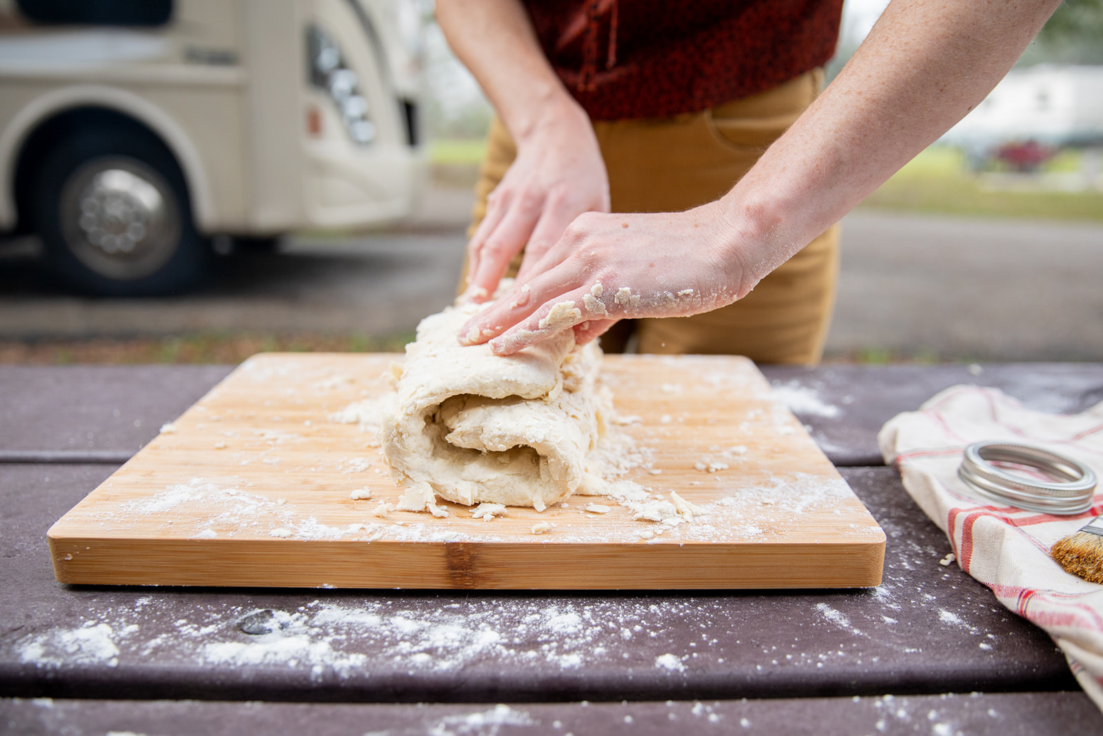 Folding dough on a cutting board. 