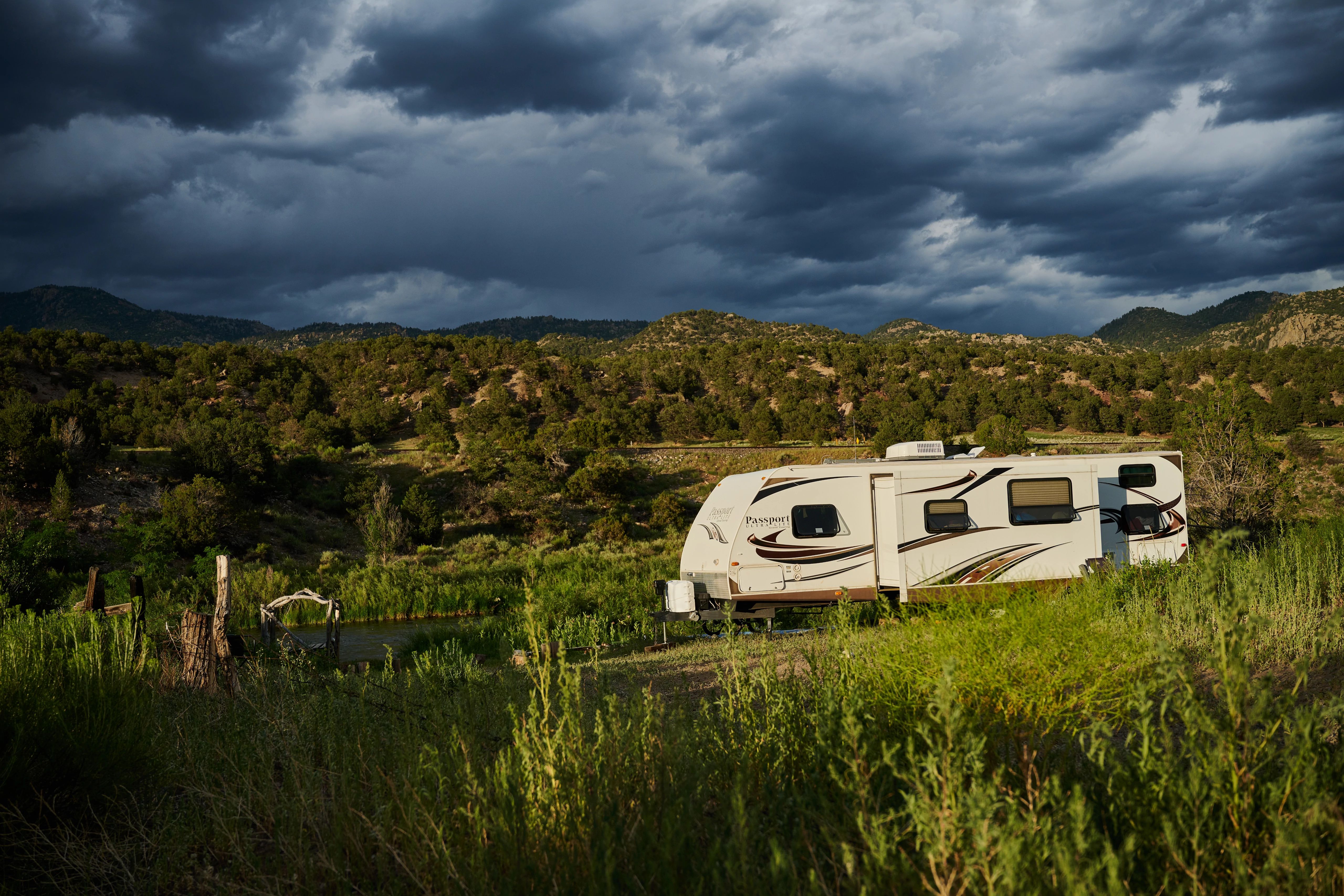 CHRIS HEUBLEIN's Keystone Passport RV parked by a river