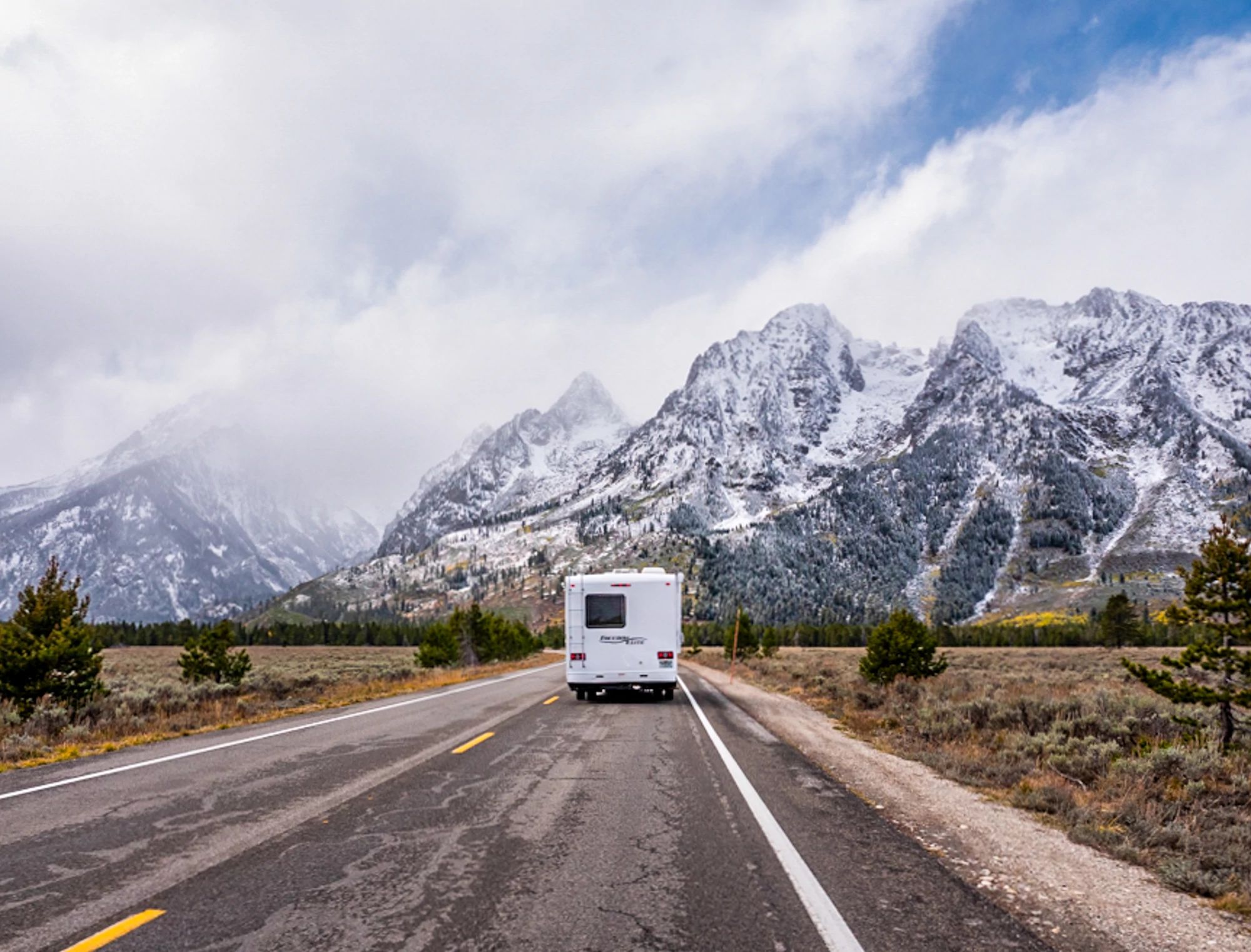 An RV driving through Grand Teton National Park