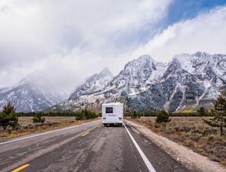 An RV driving through Grand Teton National Park