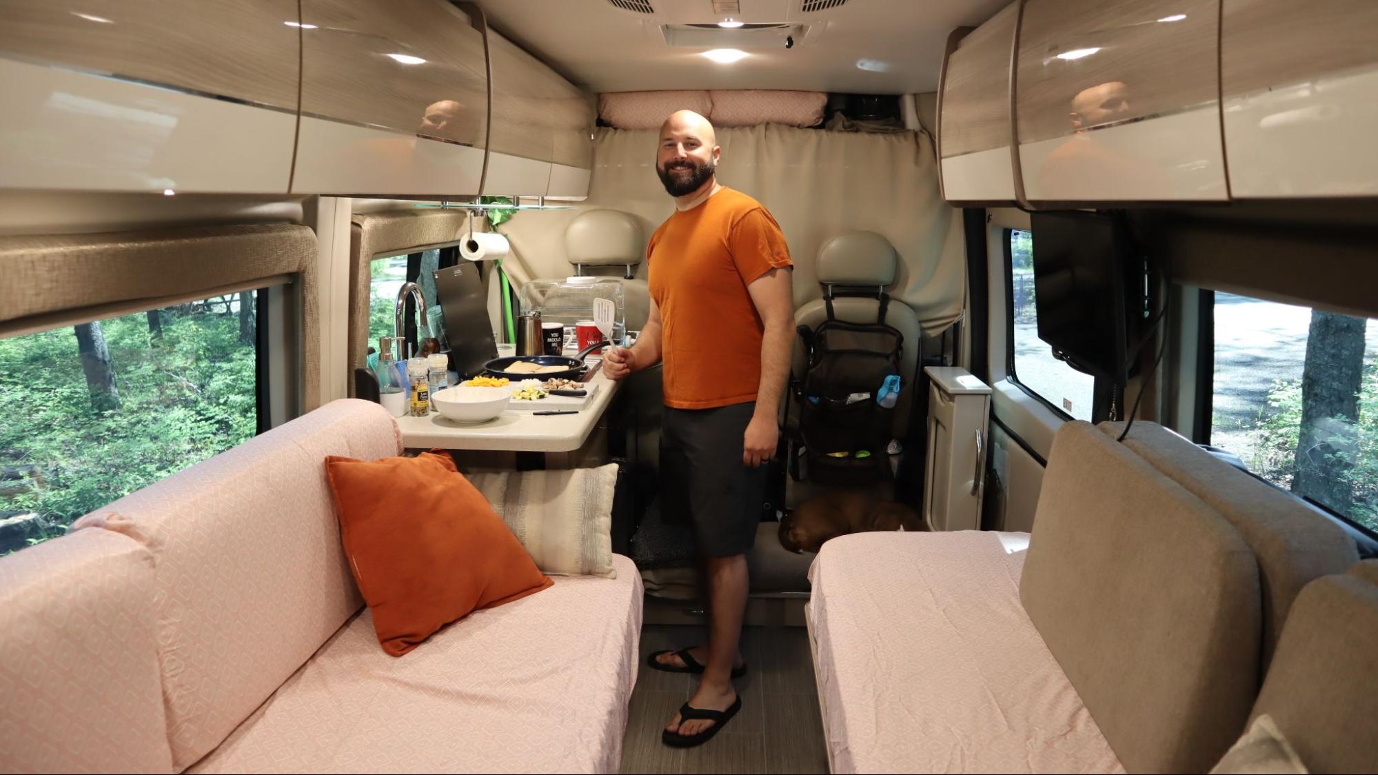 Gabe cooking breakfast inside their Class B RV.
