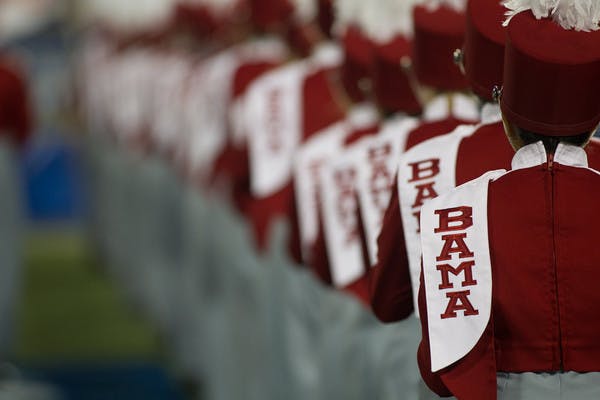 University of Alabama marching band, featuring Bama logo and crimson outfits from the back, in Tuscaloosa, Alabama.