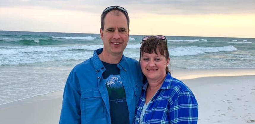 Matt and Brandy Gleason taking a photo at the beach