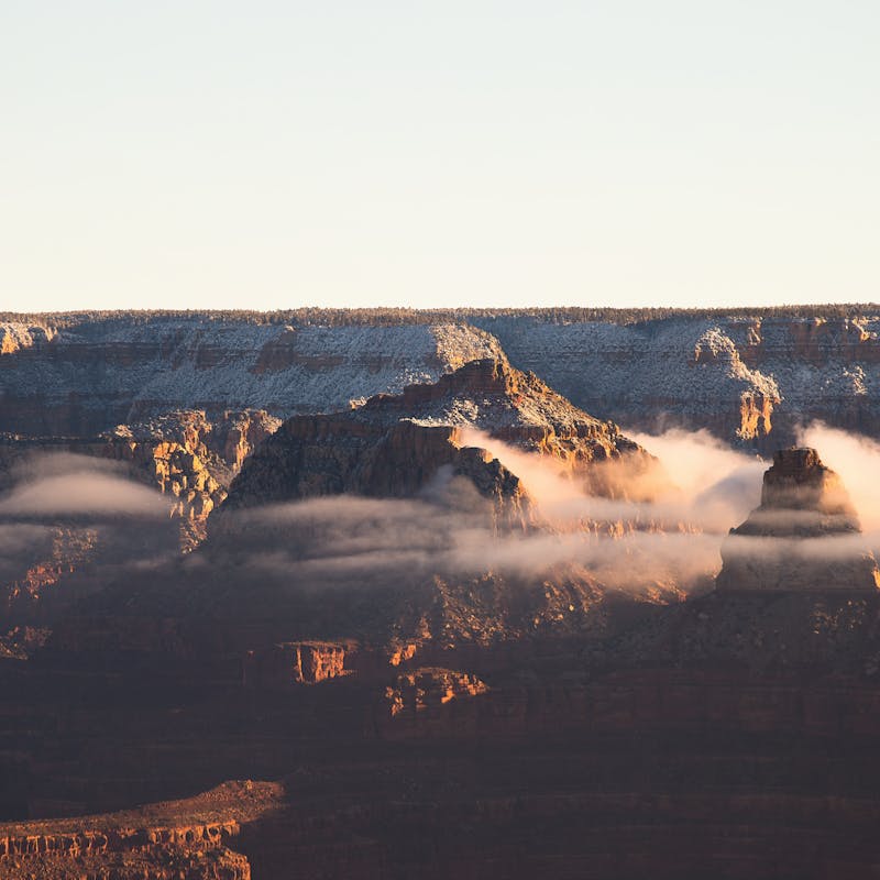 Sunset view of the Grand Canyon with clouds through the rocks
