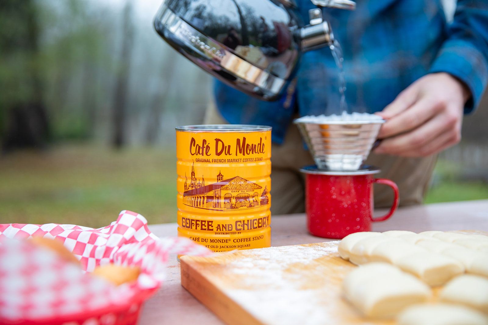 Making a pour over coffee on a picnic table. 