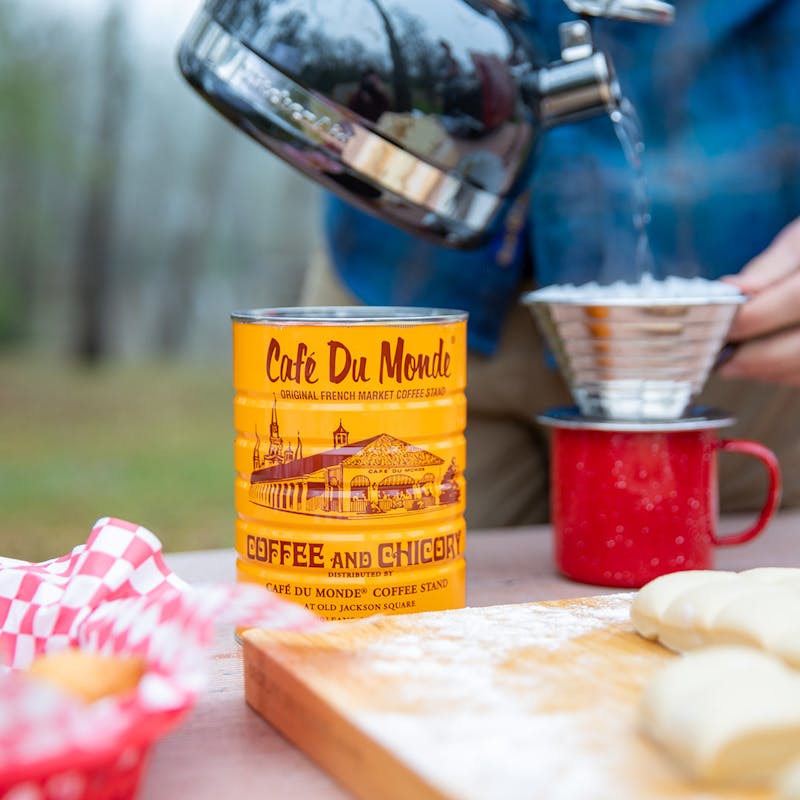 Making a pour over coffee on a picnic table.