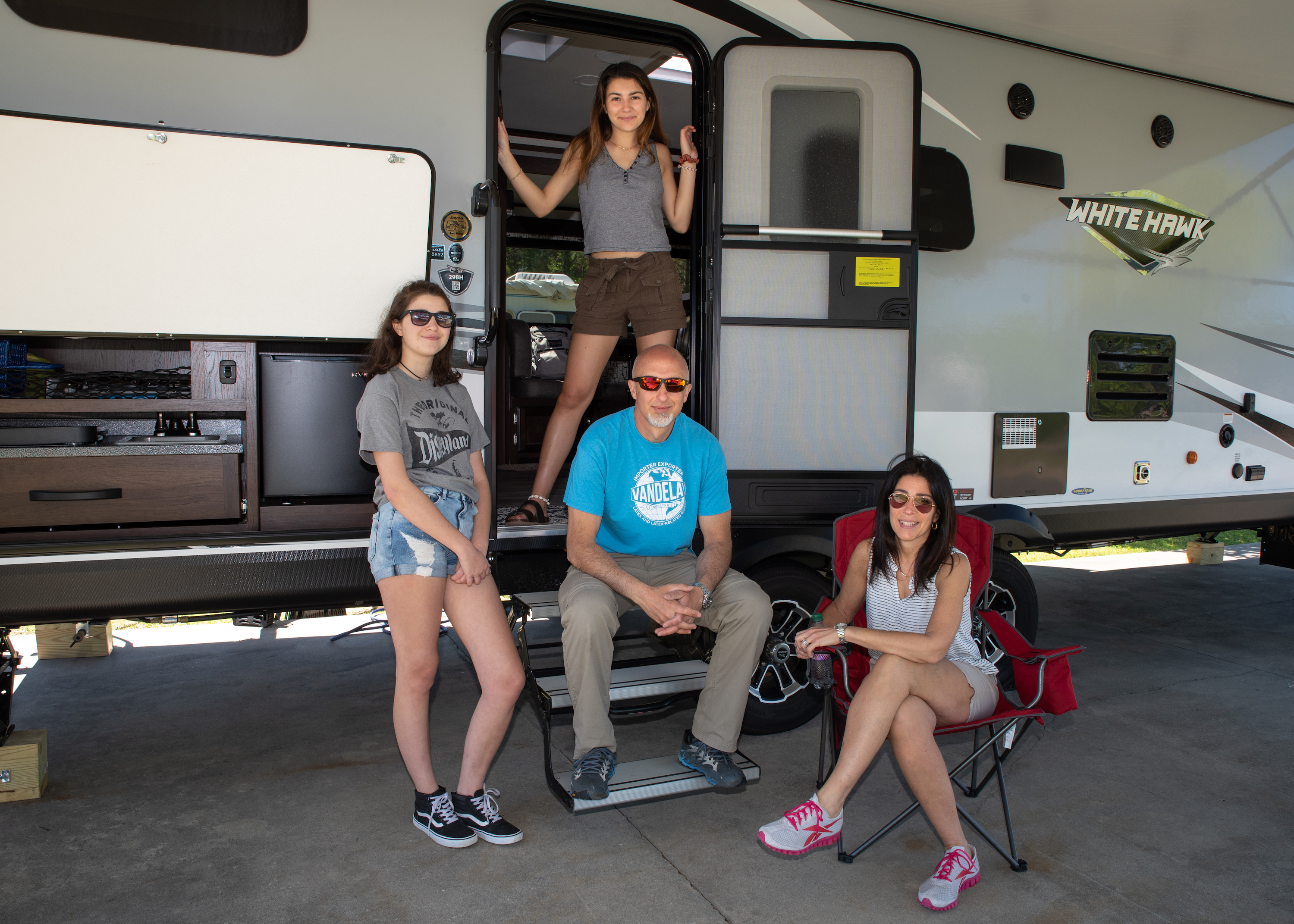 Bill Sferrazza, his wife and two daughters pose in front of their Jayco White Hawk RV.
