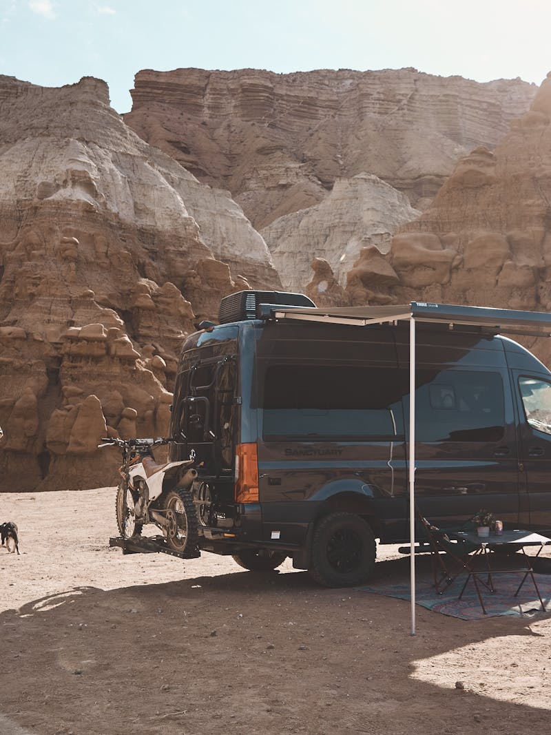 Kalen Thorien and her two dogs walk away from a TMC Sanctuary Class B RV.