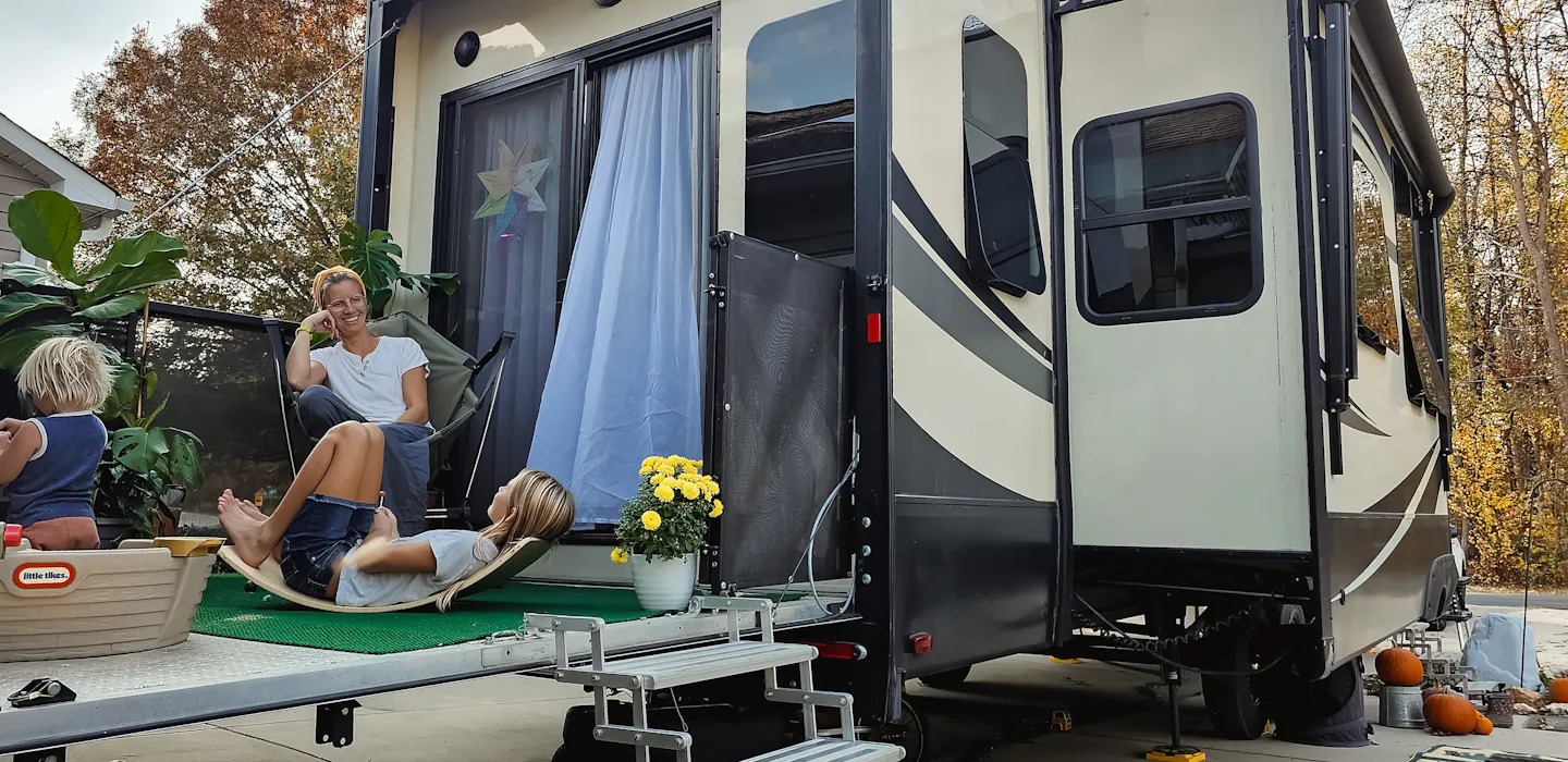 Bibi Barringer sits on the back patio of her KZ Durango Gold with her kids.