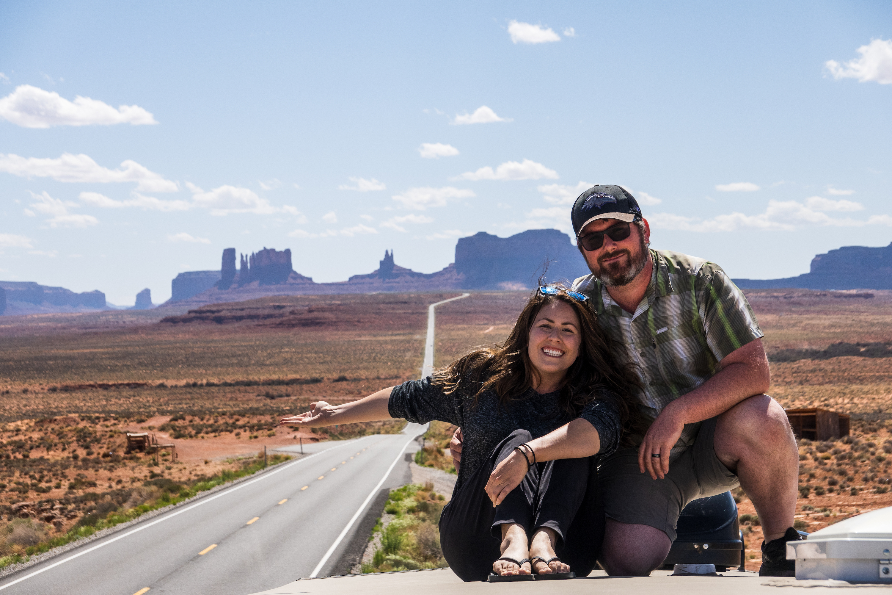 Cindy Scott and her husband sitting on top of their Keystone Cougar.