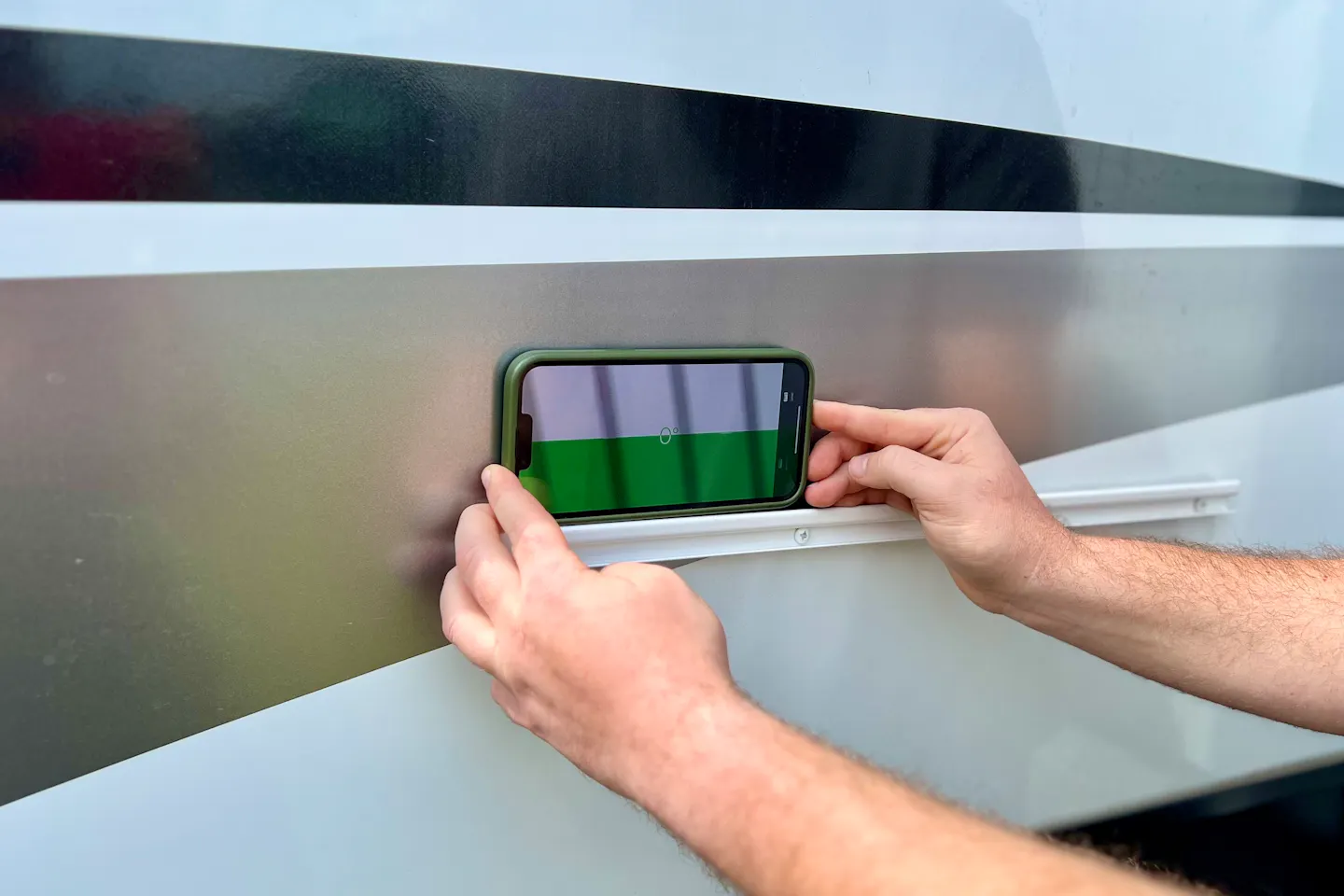 Bailey and Nicole Damberg demonstrating the leveling application on their iPhone to level their Dutchmen Fifth Wheel RV